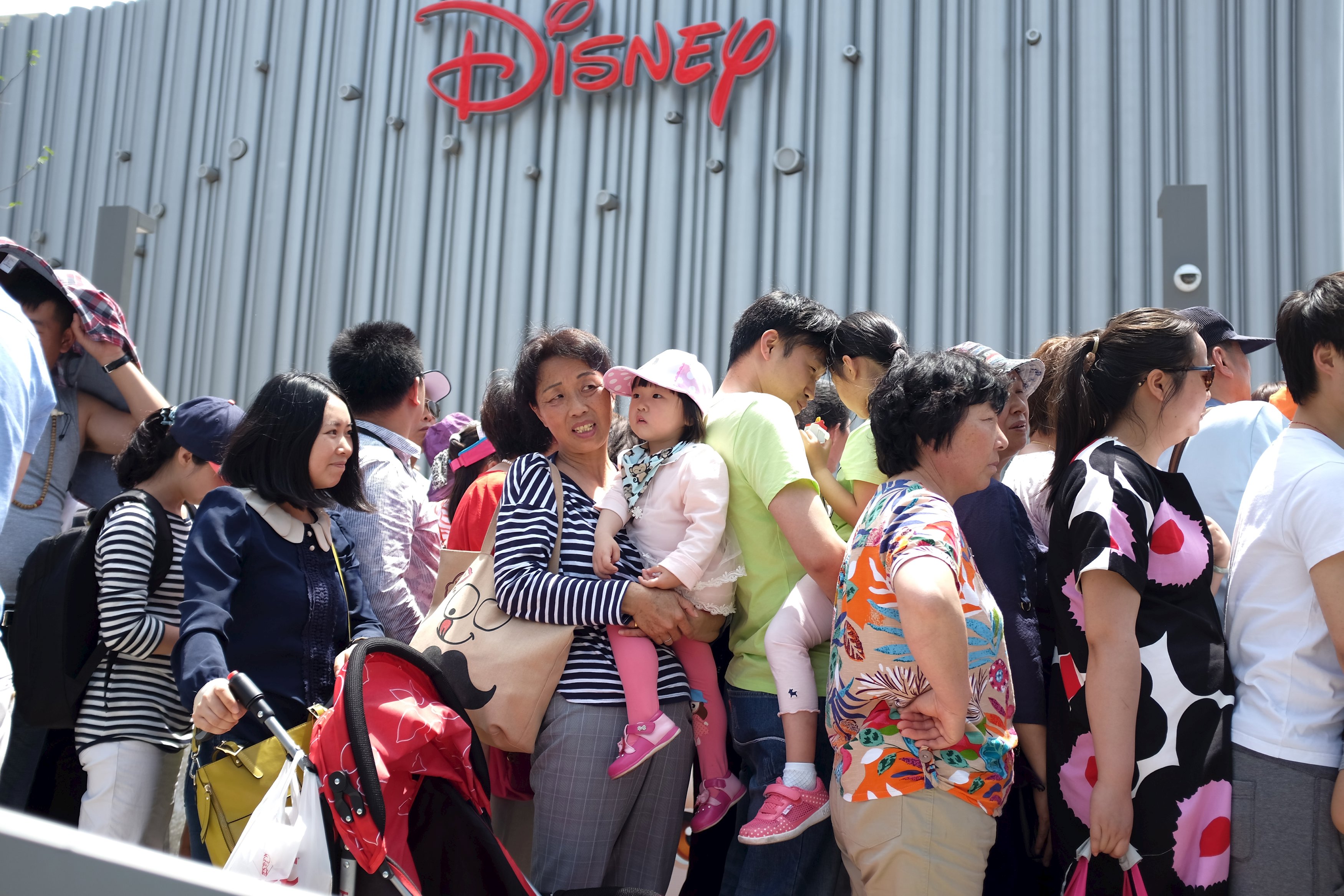 People queue to enter mainland China's first Disney store, and the world's largest, at the Pudong financial district in Shanghai. Photo: Reuters 