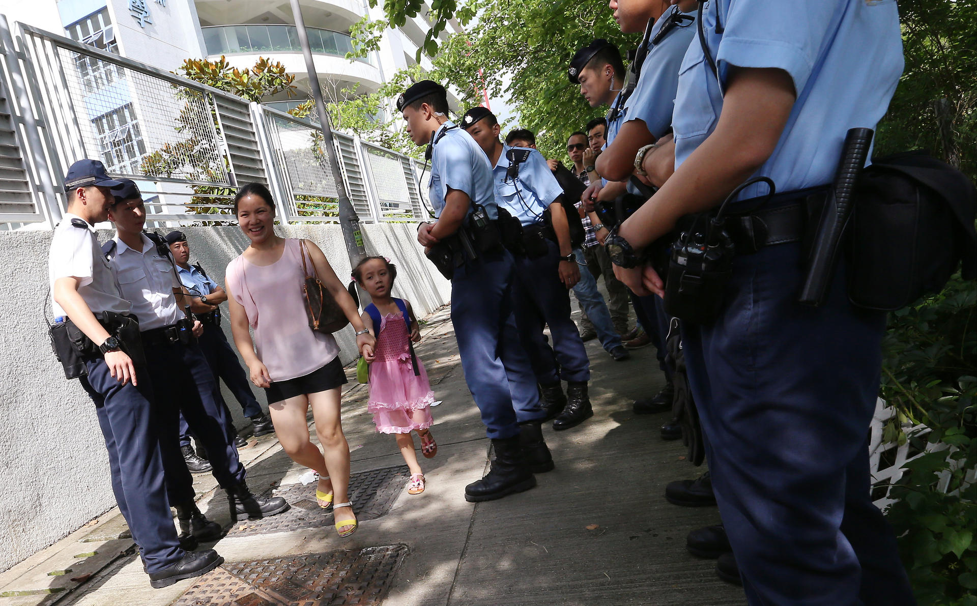 Police stand guard outside a school-place allocation centre in Sheung Shui yesterday. Photo: K. Y. Cheng