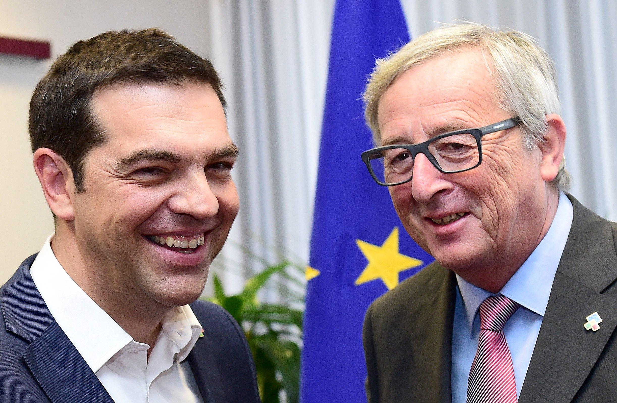 Greek Prime Minister Alexis Tsipras poses with European Commission President Jean-Claude Juncker (R) as an International Monetary Fund economist said a deal with the country will be tough on both sides. Photo: Reuters