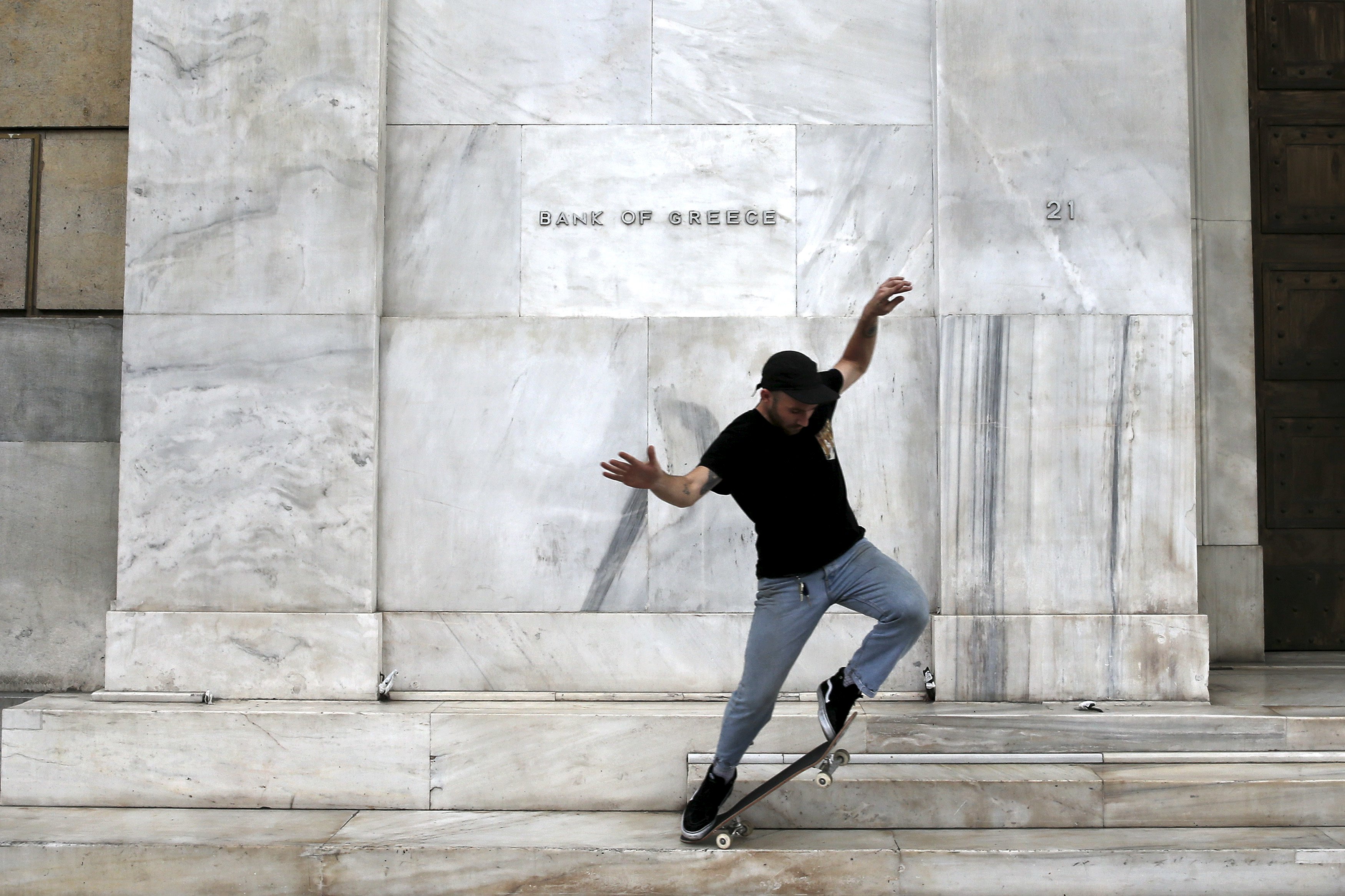 A man skateboards in front of the Bank of Greece building in Athens as talks bogged down between the government and its international creditors. The country's banks are on the verge of shutting down. Photo:  Reuters
