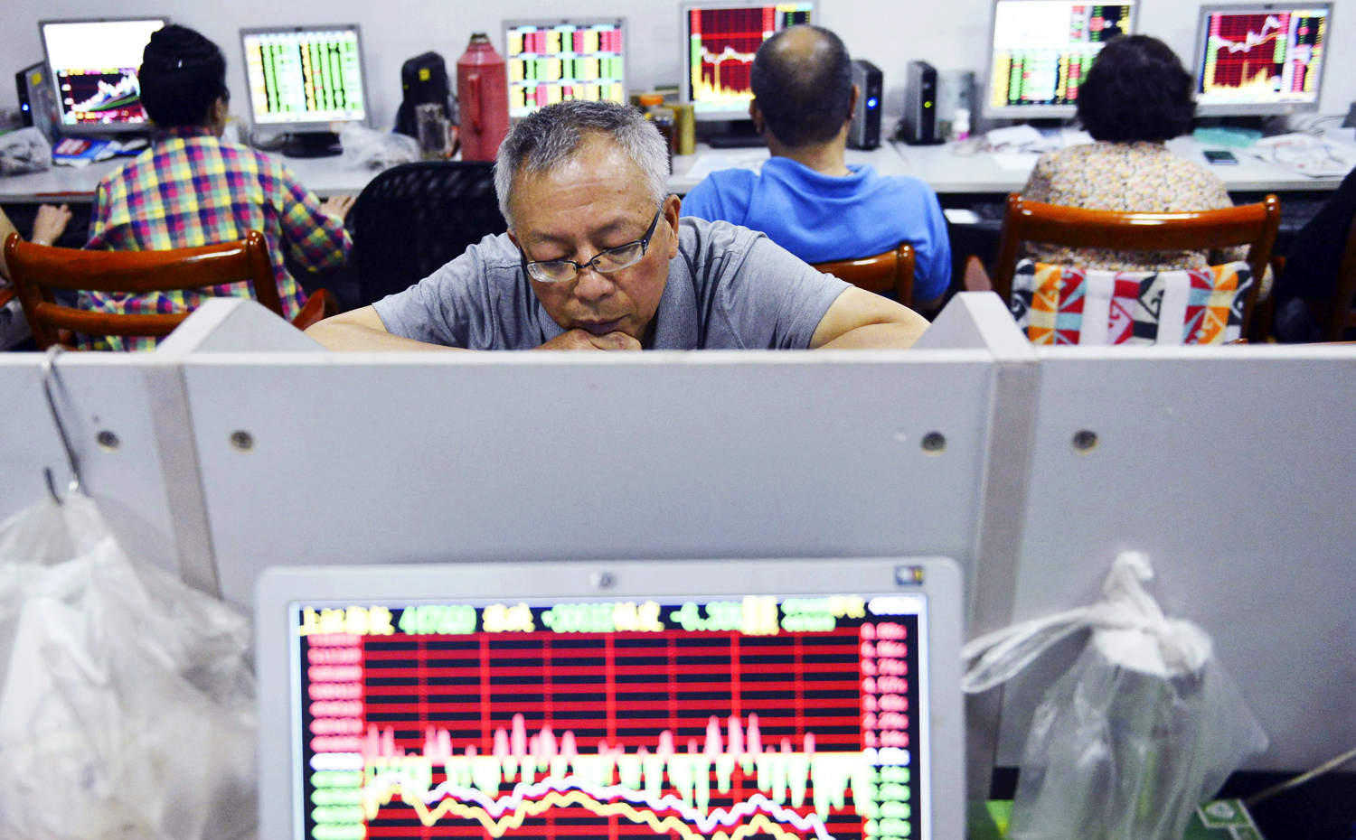 Chinese investors pore over stock prices on Monday after a rout on Friday sent indexes skidding. Photo: AP