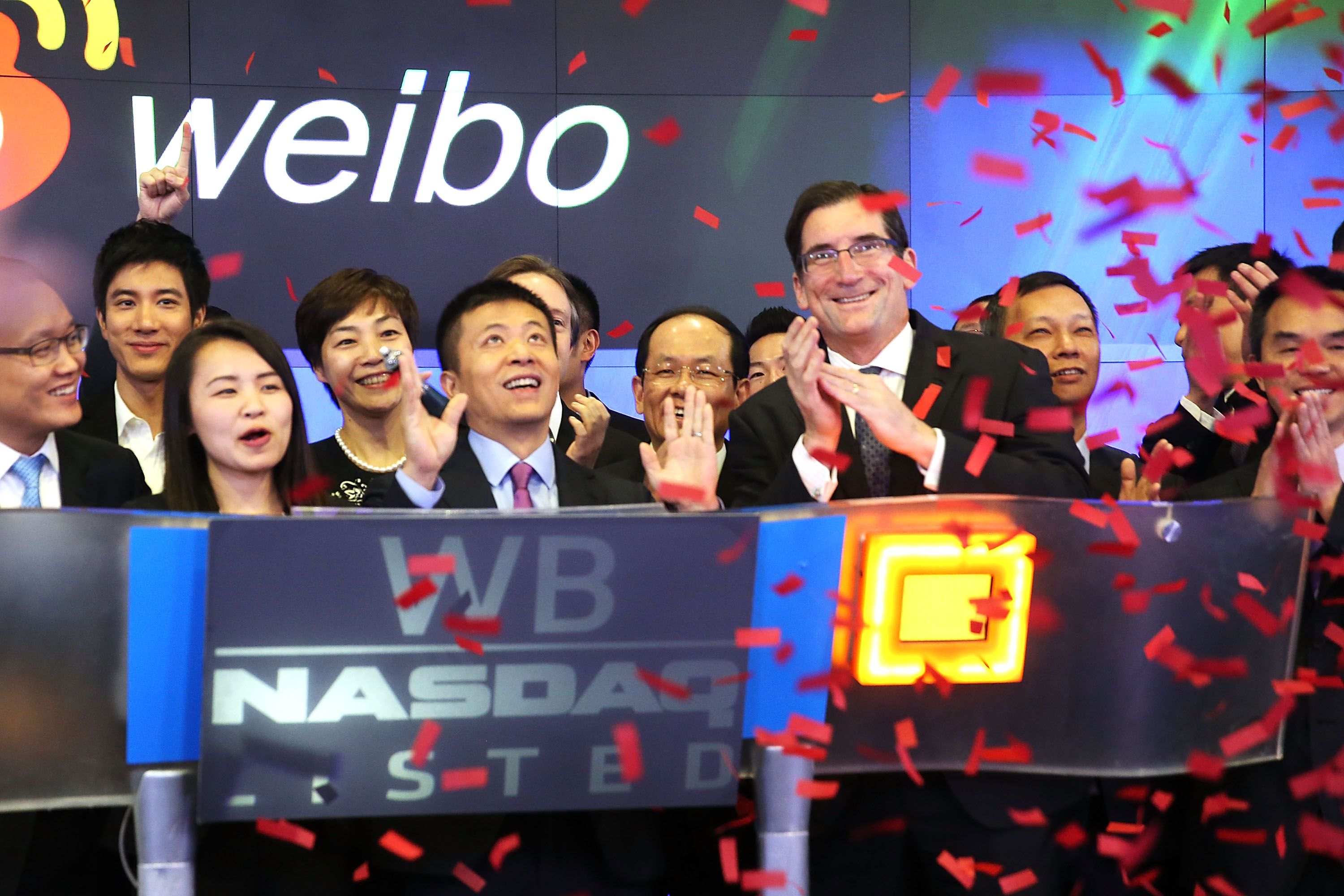 Weibo staff celebrate after the company listed on the Nasdaq. Increasingly Chinese firms are choosing to go public on local exchanges. Photo: AFP