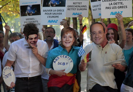 Demonstrators in Paris holding masks of (from left) Greek Prime Minister Alexis Tsipras, German Chancellor Angela Merkel and French President Francois Hollande express their opposition to bailing Greece out of debt on Monday. Photo: AFP