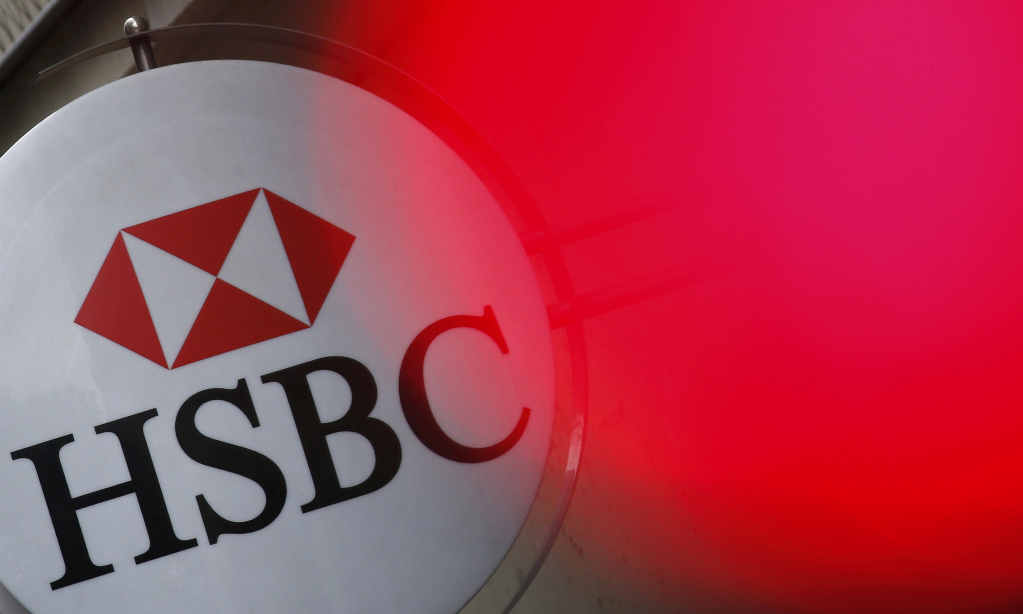An HSBC bank logo is illuminated by a traffic light in France as global lenders may find it would better to get smaller in a post-2008 crisis environment. Photo: Reuters