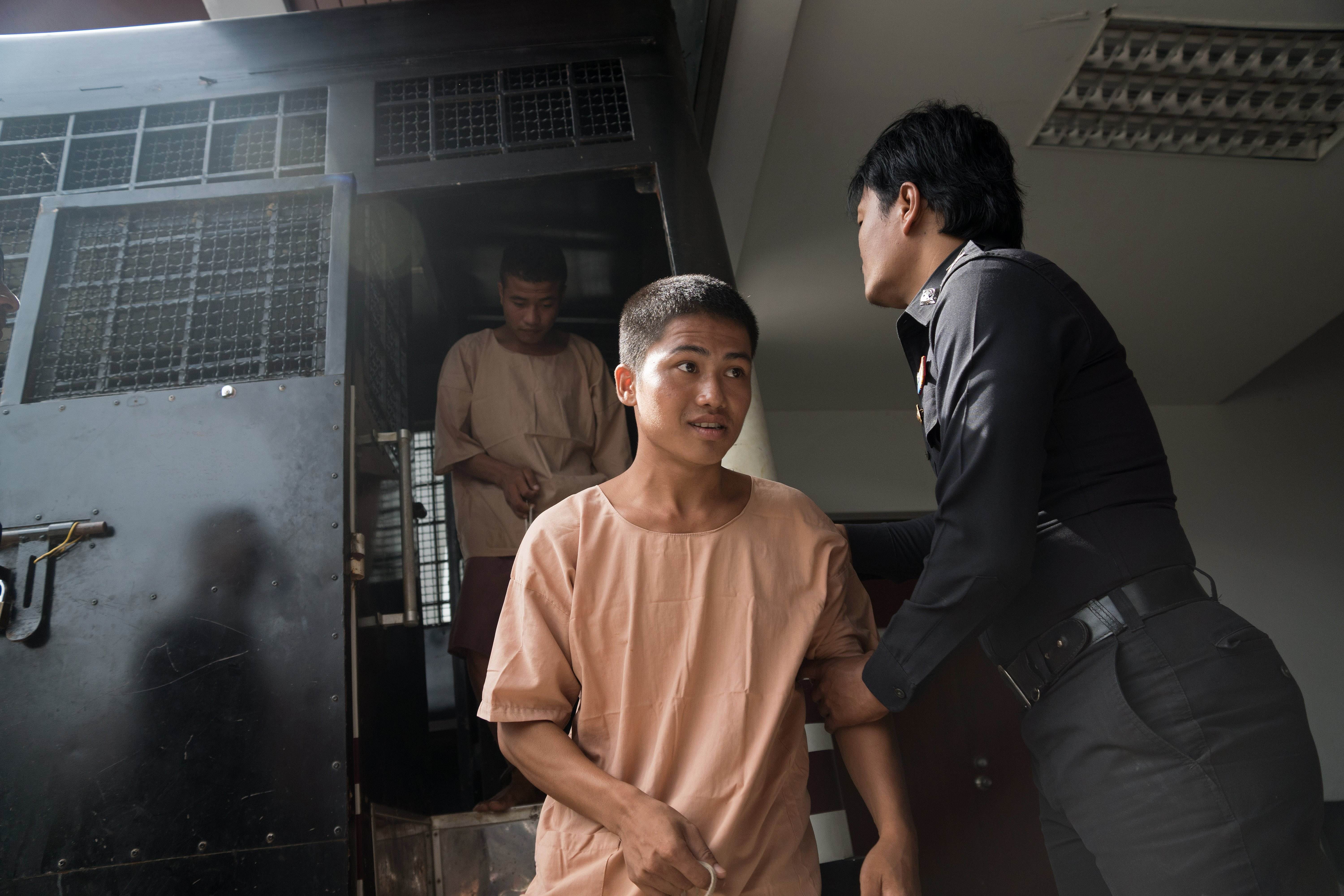 Myanmar nationals Win Zaw Htun (front) and Zaw Lin emerge from a prison van as they arrive at court for the start of their trial in Koh Samui for allegedly murdering Britons David Miller and  Hannah Witheridge. Photo: AFP