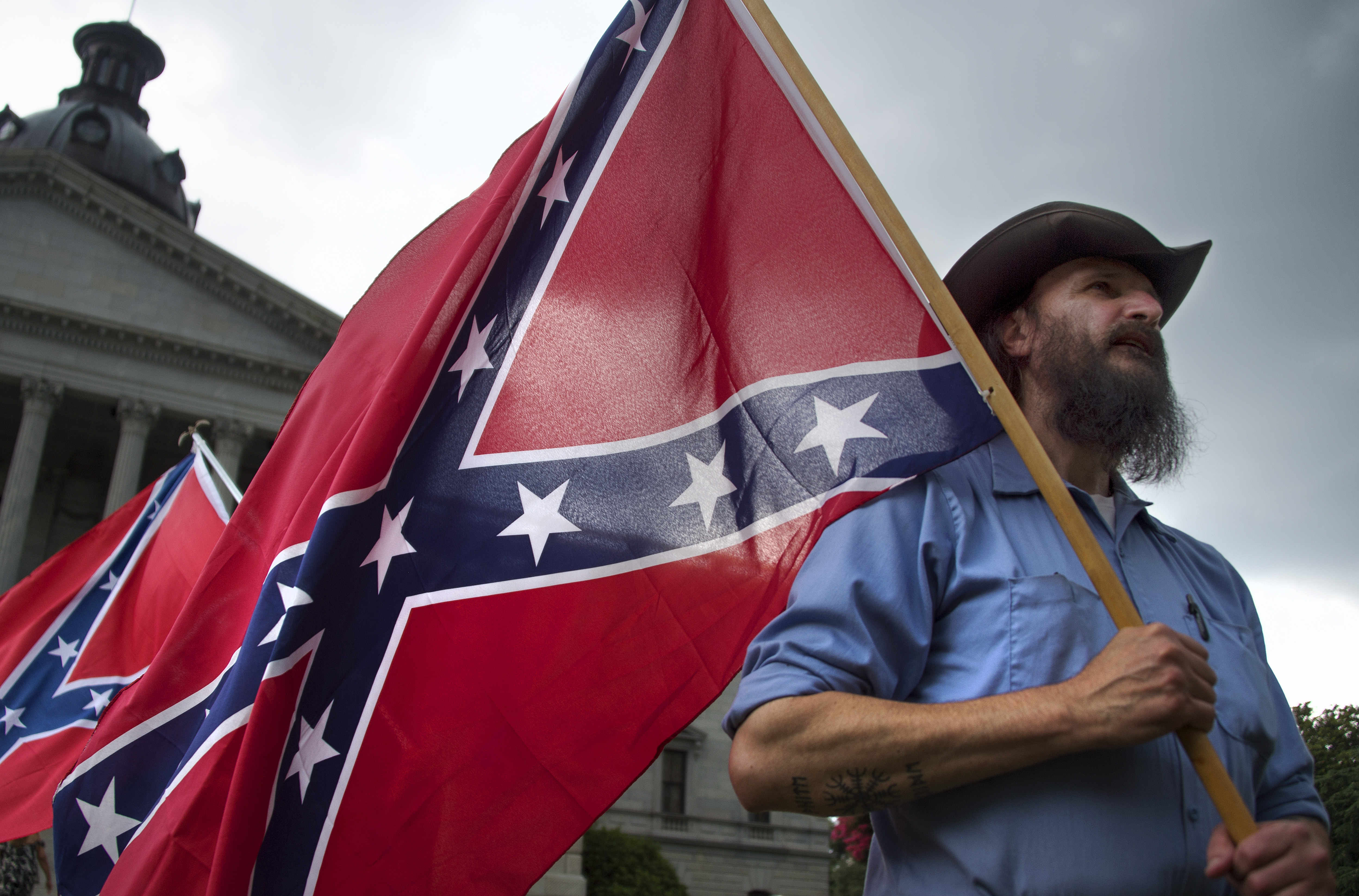 A demonstrator protesting against calls to remove the Confederate flag, seen by many as a reminder of racism's legacy, from the grounds of the state house in South California, in the wake of the shootings at the church in Charleston. Photo: AFP 