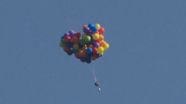 Up up and away... One brave Canadian takes to the sky in a balloon powered chair. Photo: SCMP Pictures