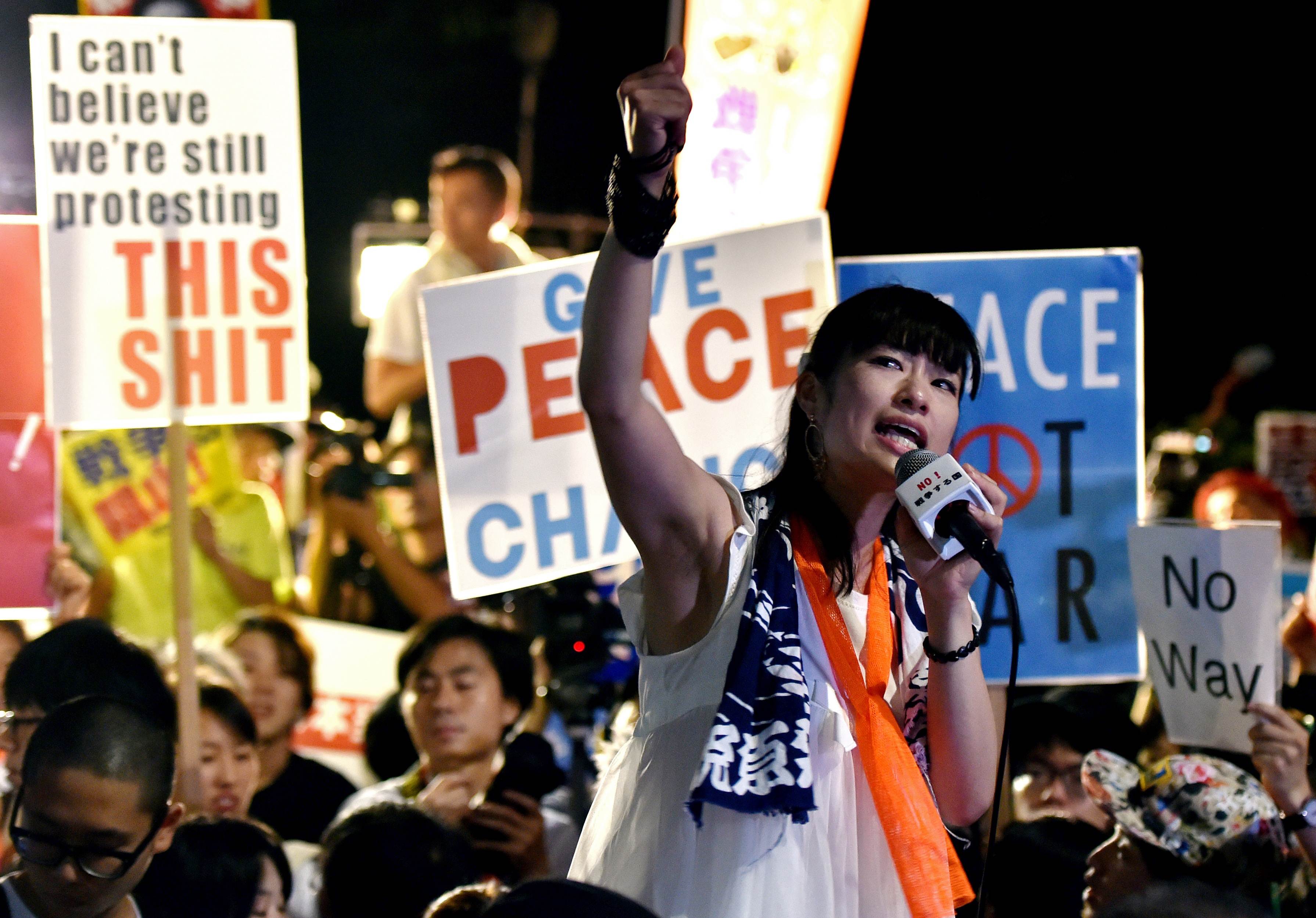 A civic group member shouts slogans during an anti-government rally outside the National Diet in Tokyo on Wednesday. Photo: AFP