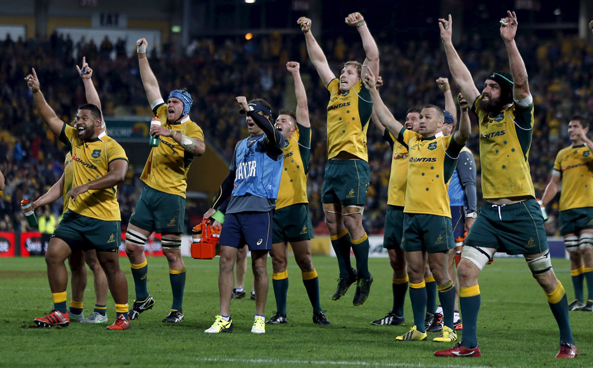 Wallabies players celebrate as they watch a television replay confirming Tevita Kuridrani’s match-winning try is good. Photo: Reuters