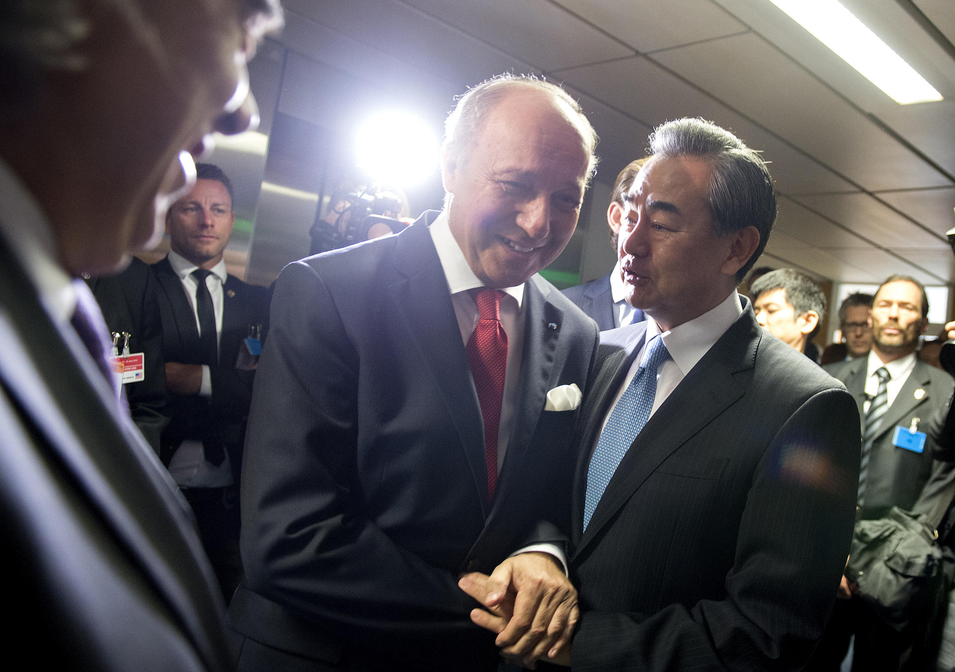 French Foreign Minister Laurent Fabius (left) chats to China's Wang Yi over Iran last week. Photo: AP