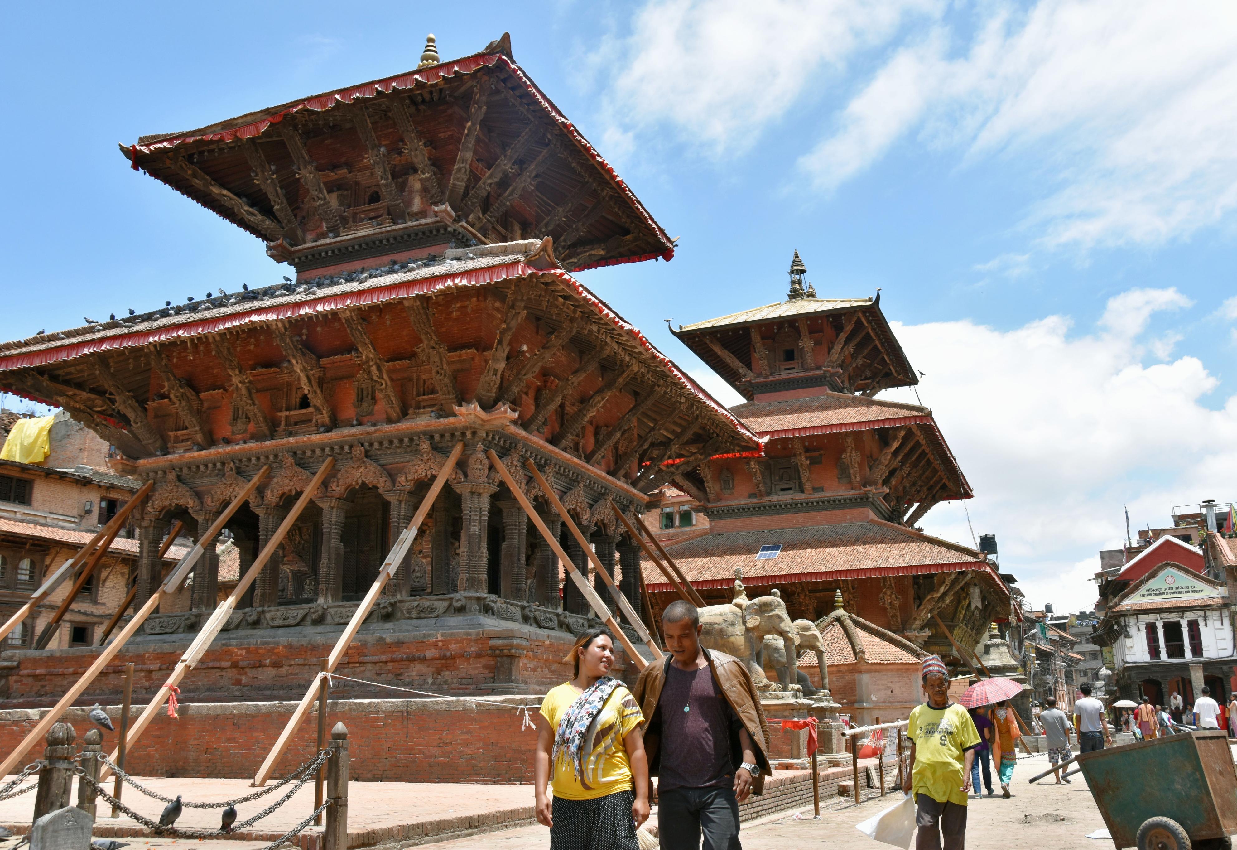 A Hindu temple is still supported by timbers at Patan Durbar Square, a UNESCO world heritage site in Kathmandu Valley in Nepal, on June 23, 2015, after it was reopened to visitors on June 15 in an attempt to bring tourism back to the region following April's devastating earthquakes. Photo: Kyodo