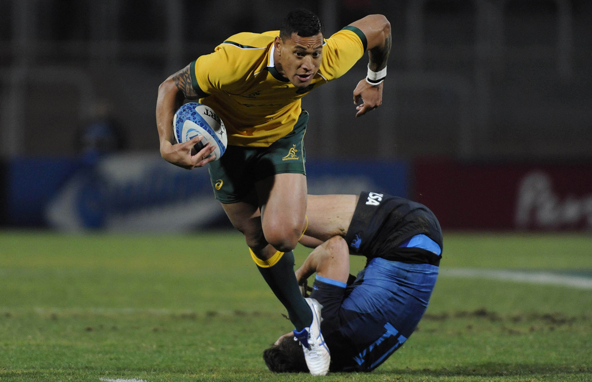 Israel Folau slips a tackle from Argentina’s Juan Imhoff during Australia’s 34-9 Rugby Championship victory in Mendoza on Saturday. Photos: AFP