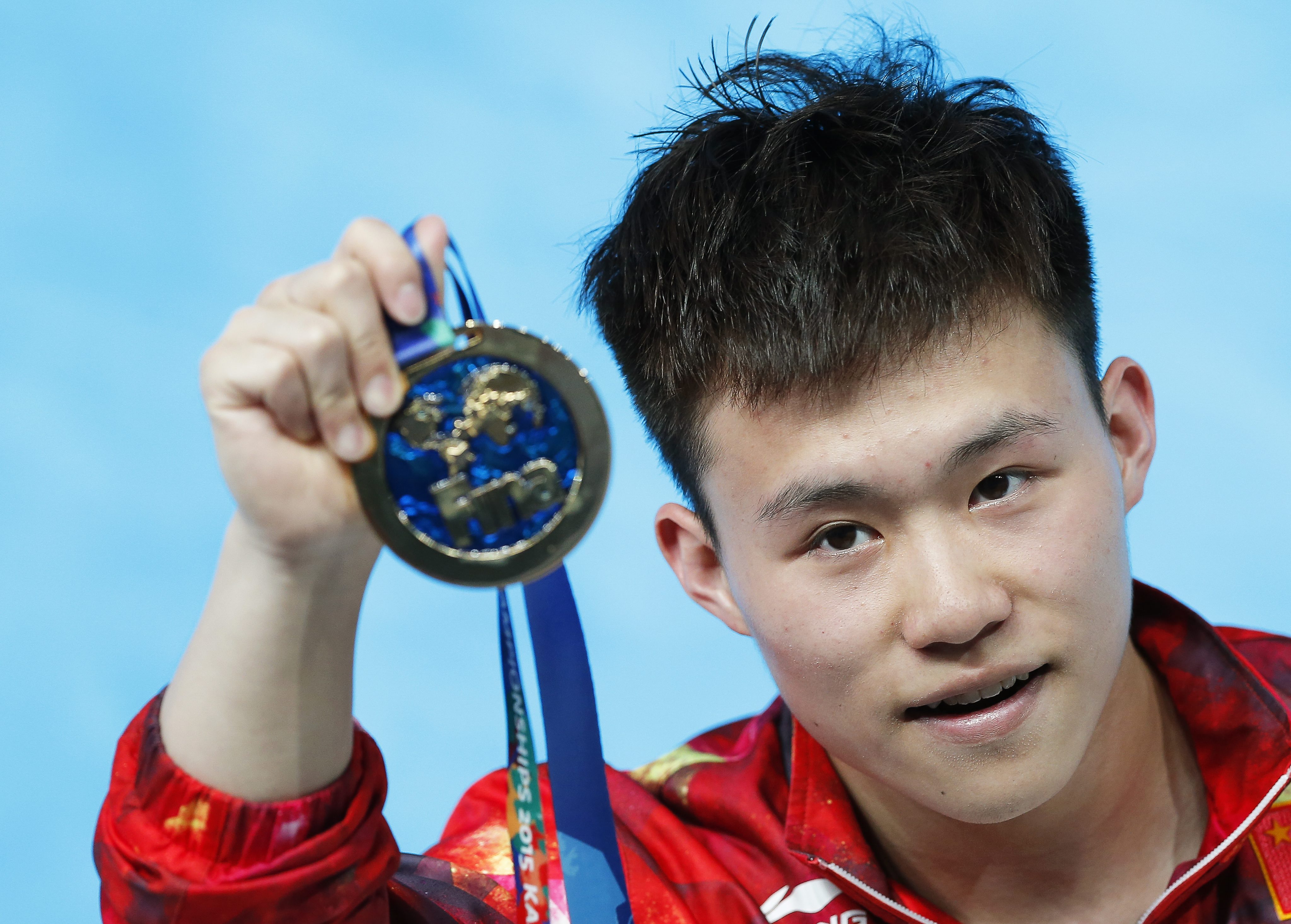 Teenager Xie Siyi with his gold. Photo: EPA
