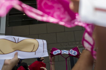 A protester holds up a bra with a sign during a demonstration in support of protester Ng Lai-ying. Photo: Reuters