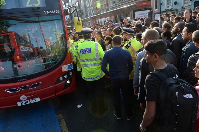 Police try to maintain order amid a crush for buses in Stratford after the start of the strike on Wednesday. Photo: AP