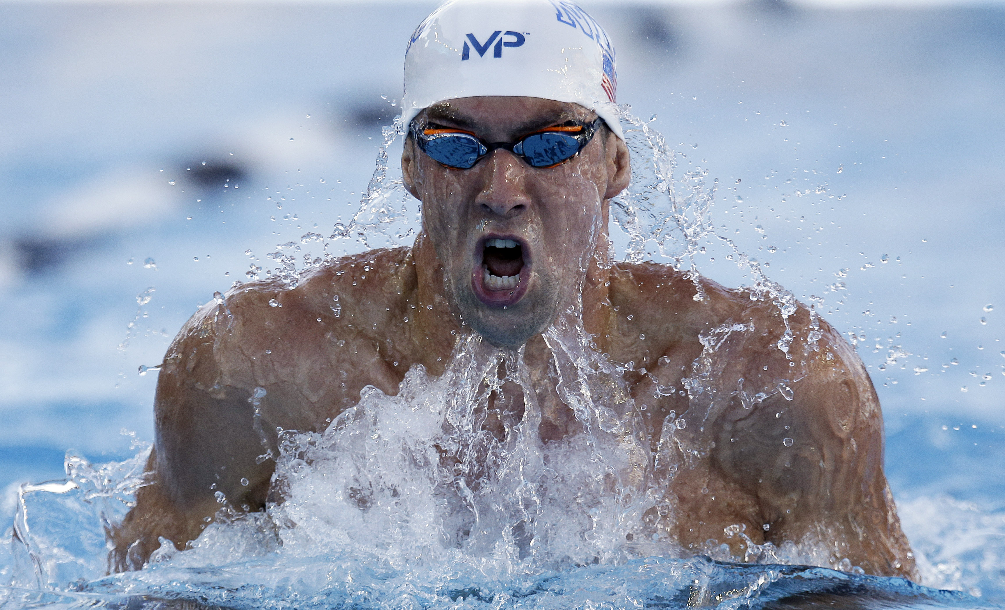 Michael Phelps carves through the water on the breaststroke leg of the 200m individual relay. Photo: AP