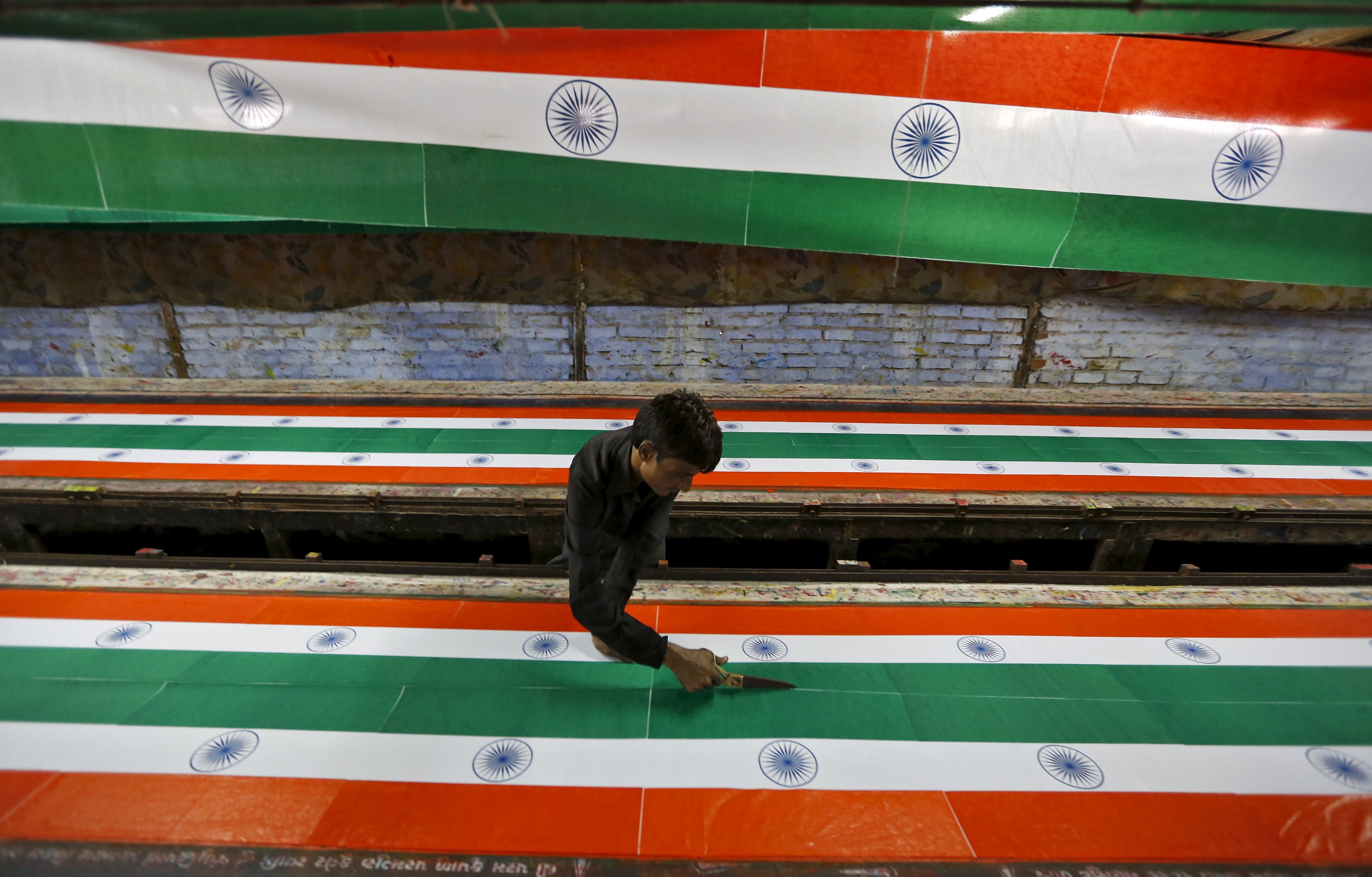 Indian national flags are being made ahead of the country's independence day on August 15. Industrialisation has great potential in India. Photo: Reuters