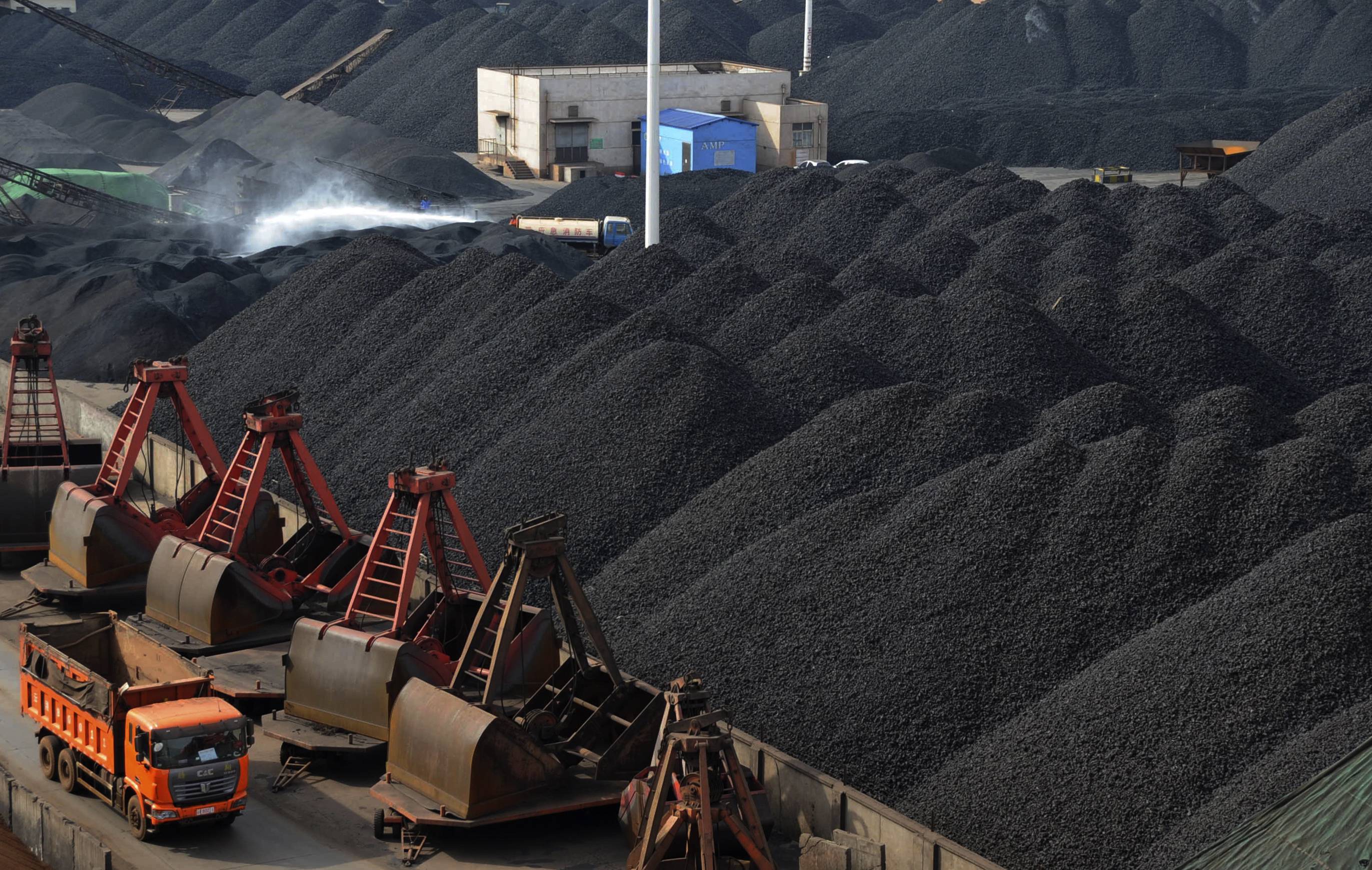 Trucks haul mountains of coal in China as imports of the material surged in July although most in the trade doubt it can be sustained. Photo: Reuters 