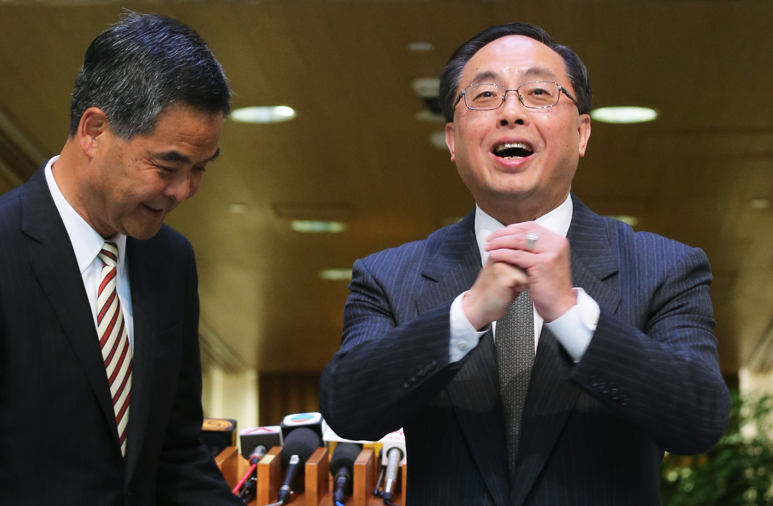 Hong Kong chief executive Leung Chun-ying (left) and his advisor Nicholas Yang Wei-hsiung, who had to walk back comments praising Uber this week. Photo: David Wong