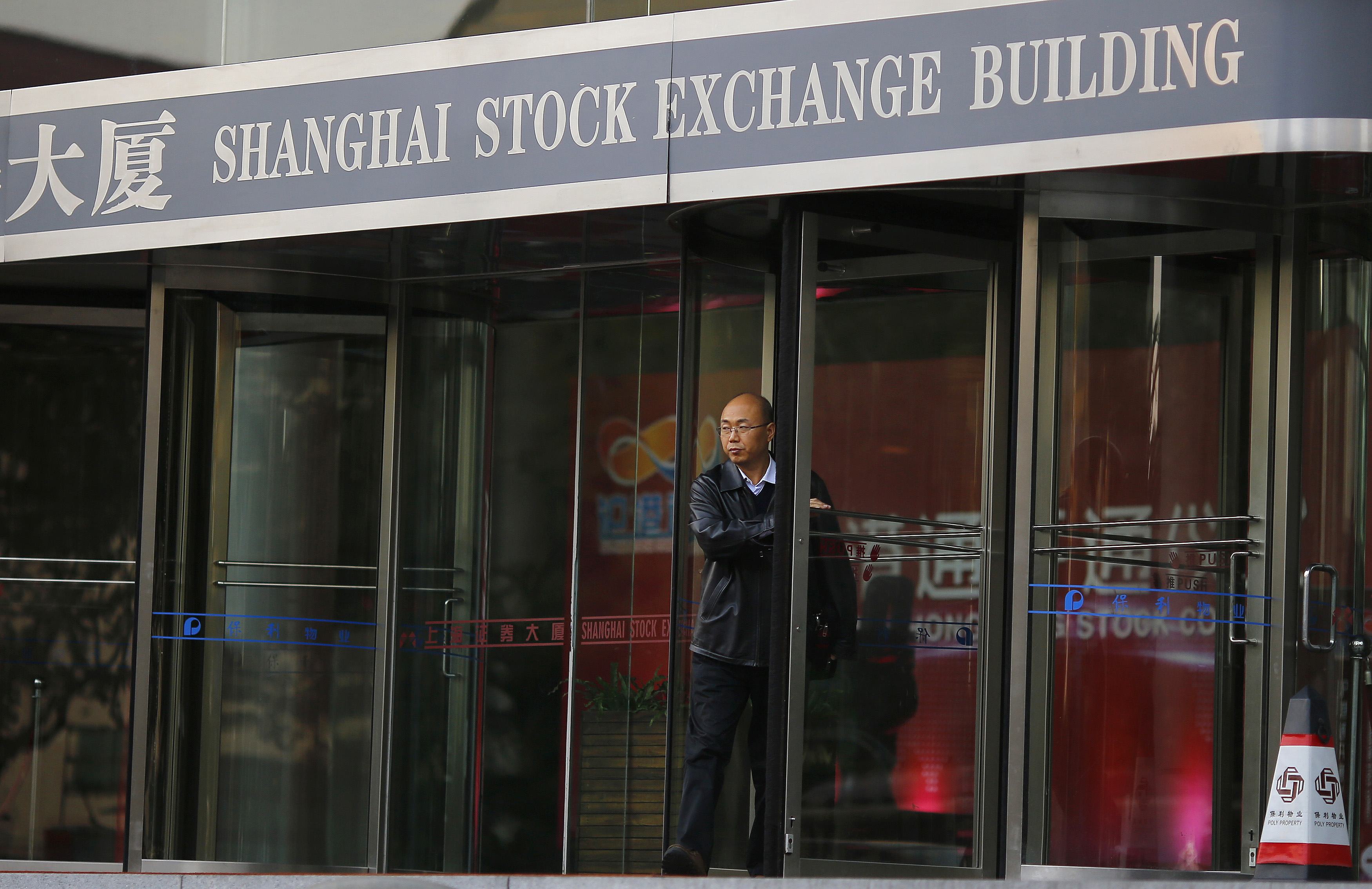 The entrance to the Shanghai Stock Exchange building as shares in China's top exchange are called to open on Tuesday almost flat after a steep rout on Monday. Photo: Reuters 