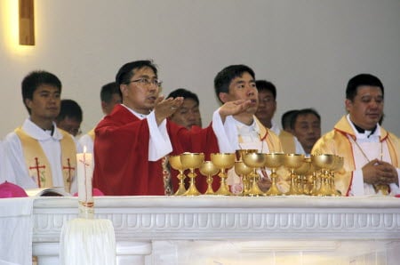Father Joseph Zhang (in red) became the first bishop ordained on the mainland in three years. Photo: AP