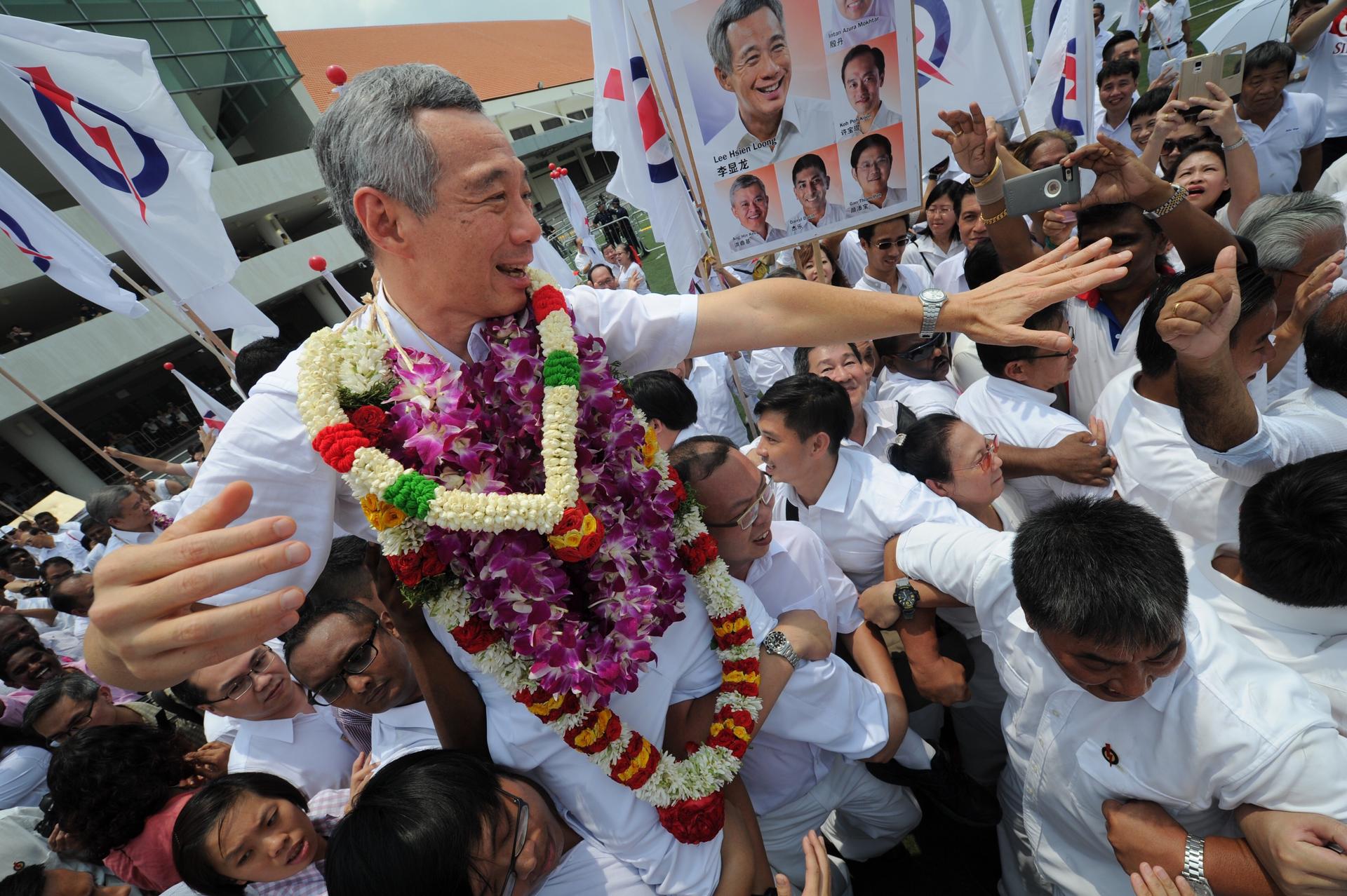 Singapore's Prime Minister Lee Hsien Loong interacts with supporters of his People's Action Party as campaigning begins. Photo: Xinhua