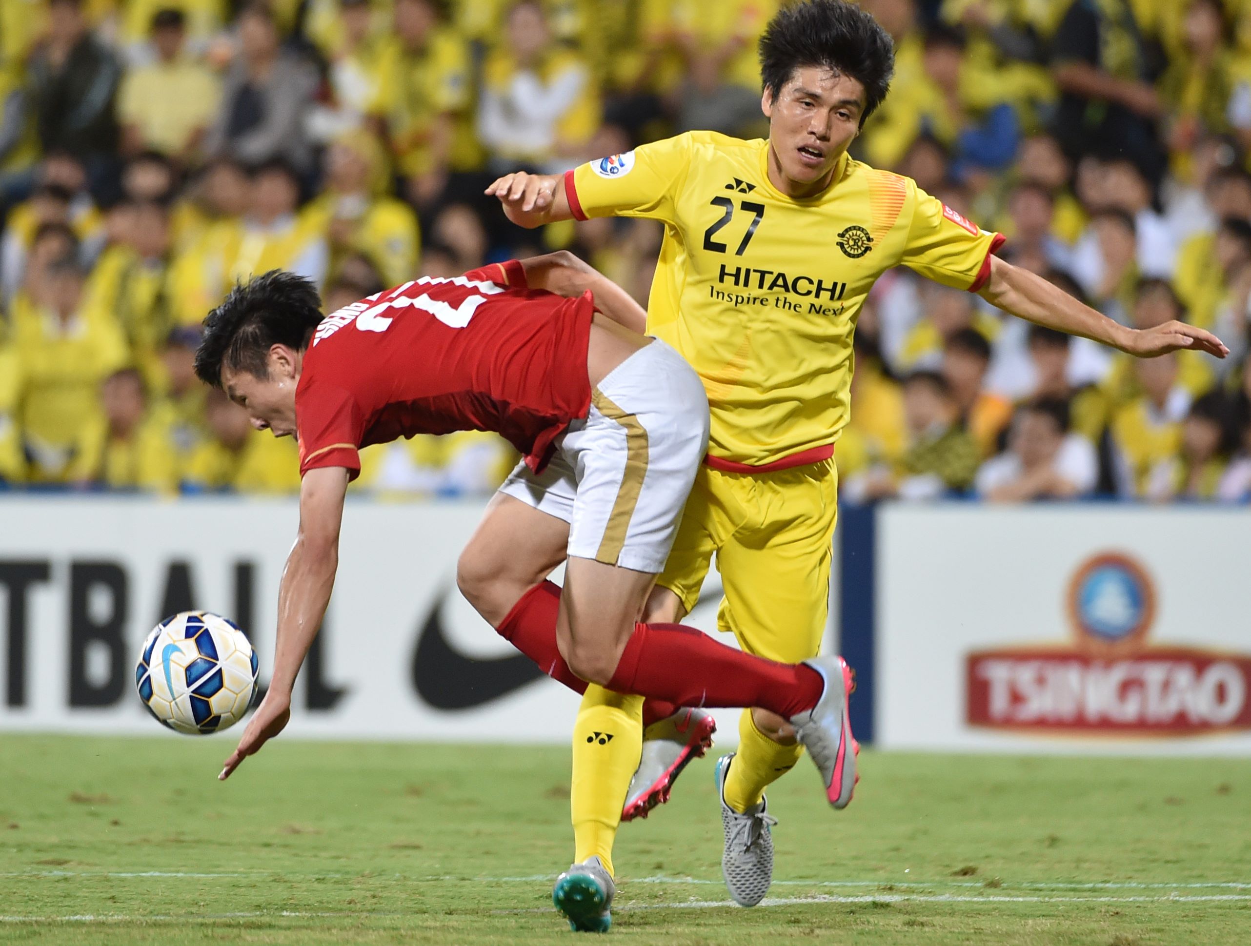 Guangzhou Evergrande midfielder Zheng Long, left, fights for the ball durjng an AFC Champions League quarterfinal match last month. Alibaba founder Jack Ma Yun bought 40 per cent of the team last year after getting drunk with its owner. He now has bigger plans for China's sports industry. Photo: AFP