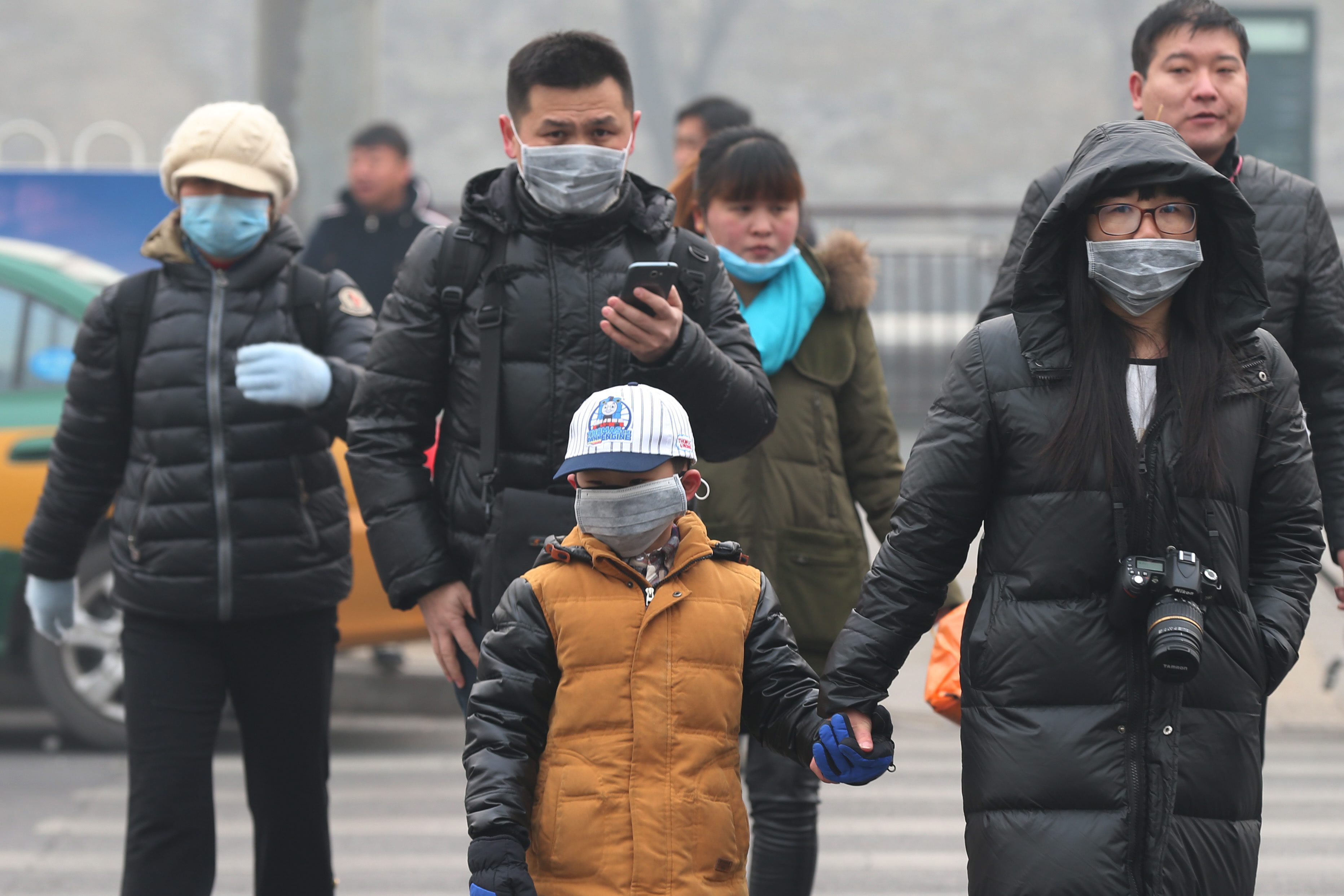 People in Beijing and many other cities in northern China are back wearing face masks following the return of thick smog. File photo: EPA