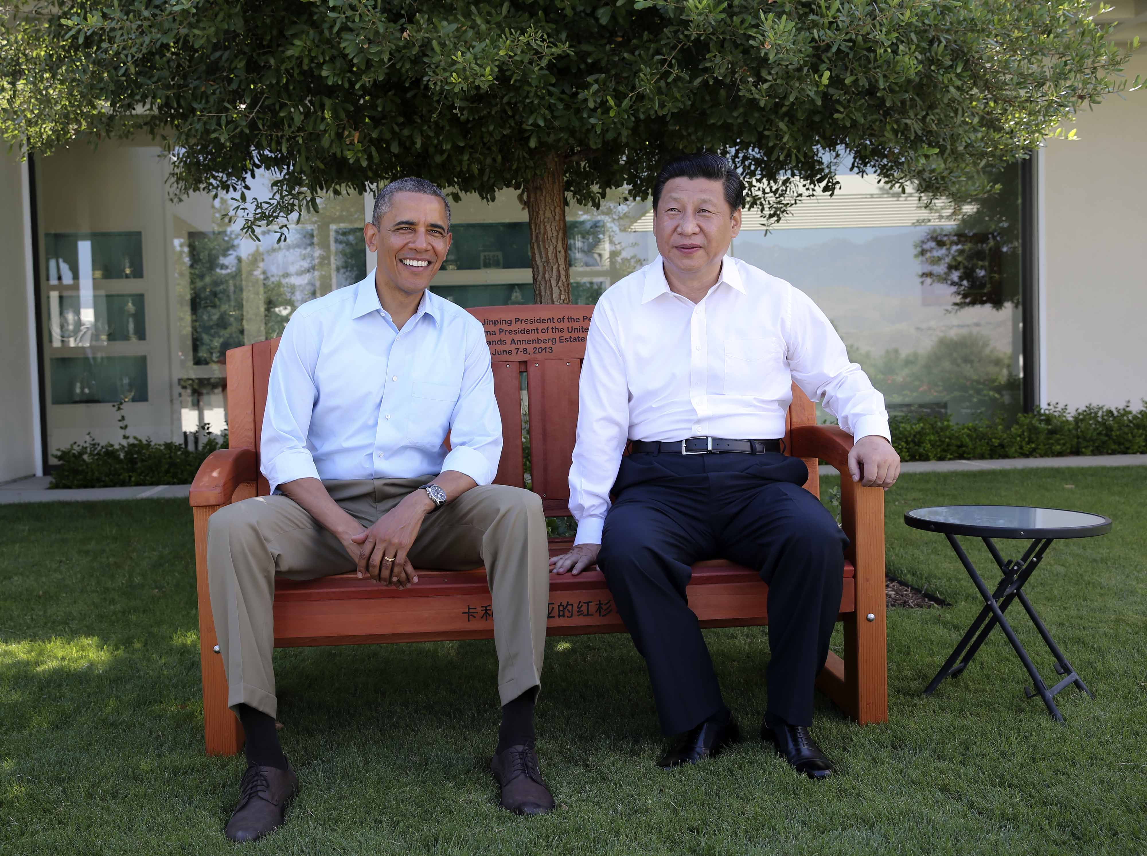 Barack Obama presents Xi Jinping with a bench made of California redwood before they head into their meeting at the Annenberg Retreat in June 2013. Photo: Xinhua