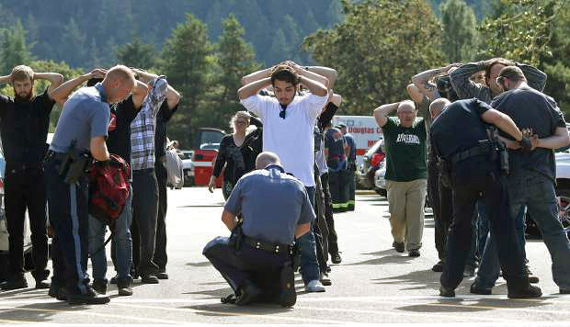 Police search students outside Umpqua Community College in Roseburg. Photo: AP