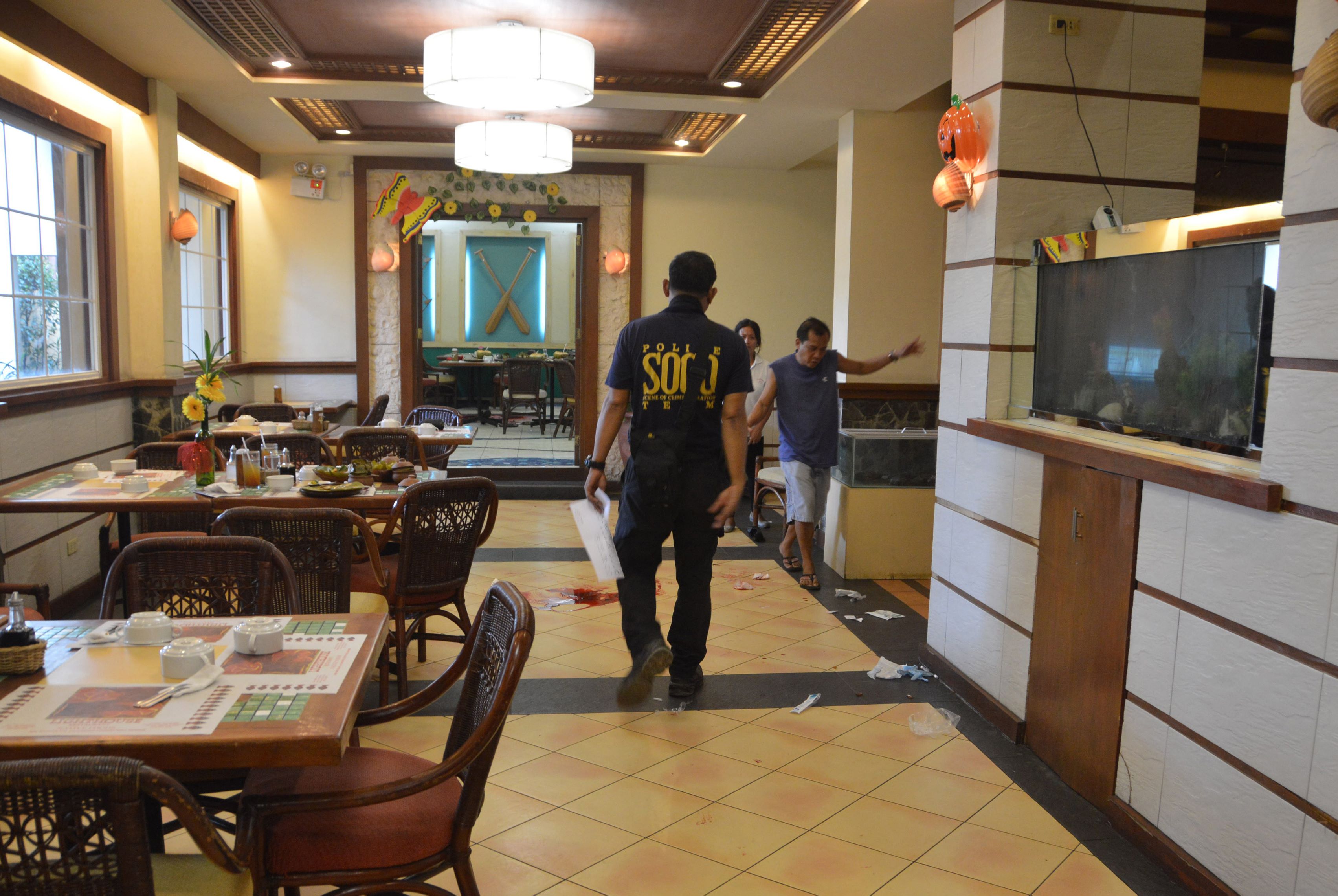 A police investigator inspects the crime scene where Chinese consul general Song Ronghua was wounded after a shooting incident at a restaurant, in Cebu City, central Philippines. Photo: AFP