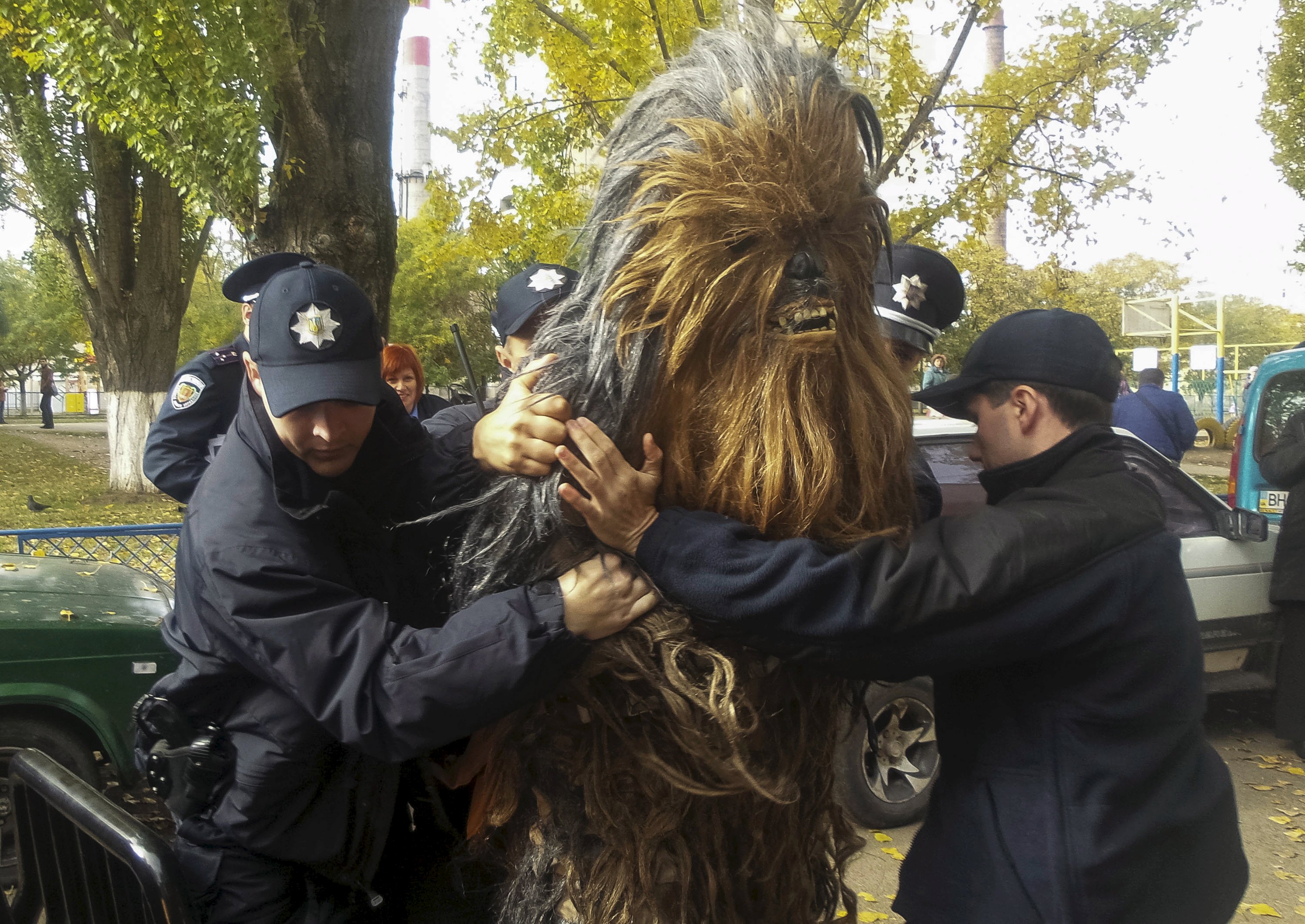Chewbacca resisted four law enforcement officers, who were forced to pin him down on the hood of a van  to handcuff him. Photo: Reuters
