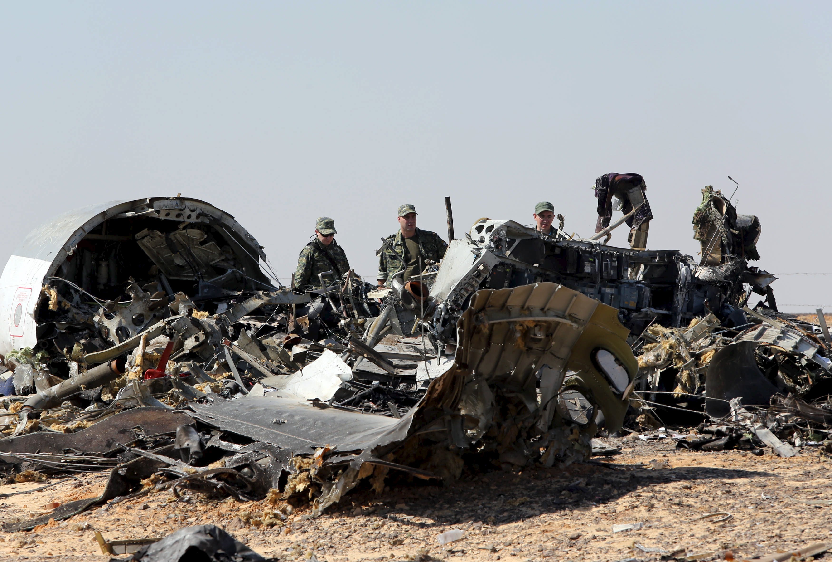 Military investigators from Russia stand near the debris of a Russian airliner at the crash site. Photo: Reuters