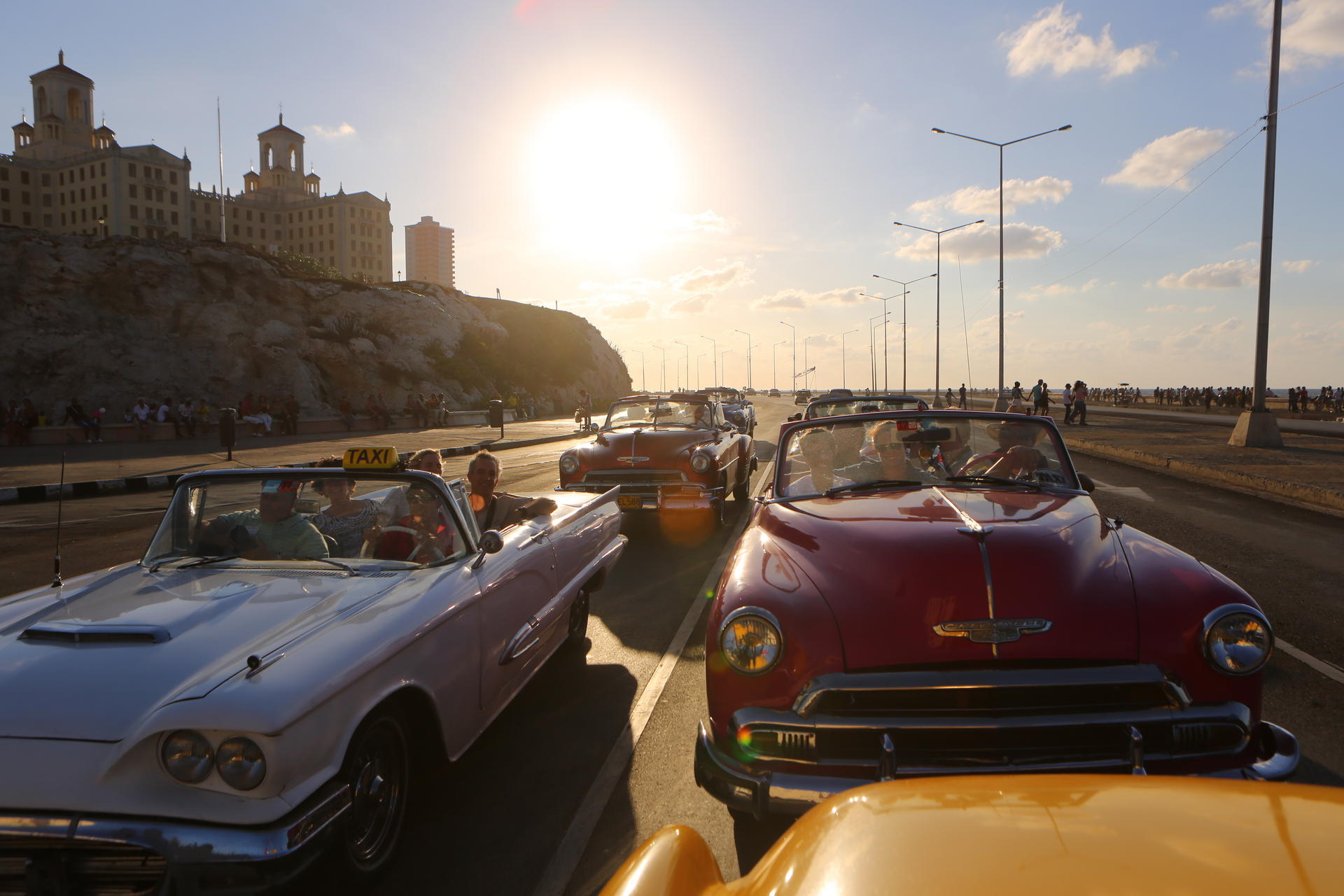 Classic cars cruise through Vedado, in Havana.