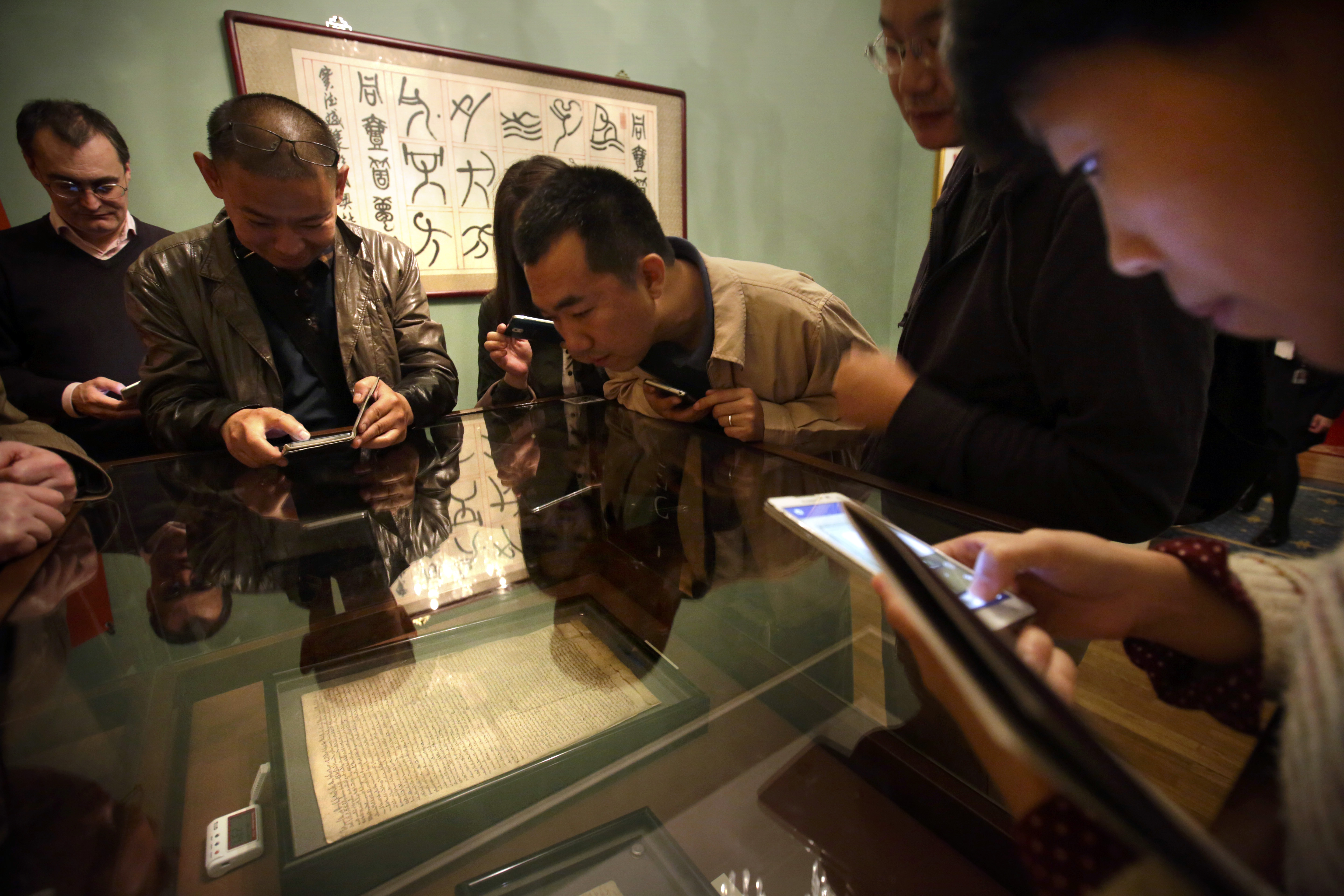 Visitors in Beijing examine the Magna Carta that will arrive in Hong Kong this week. Photo: AP