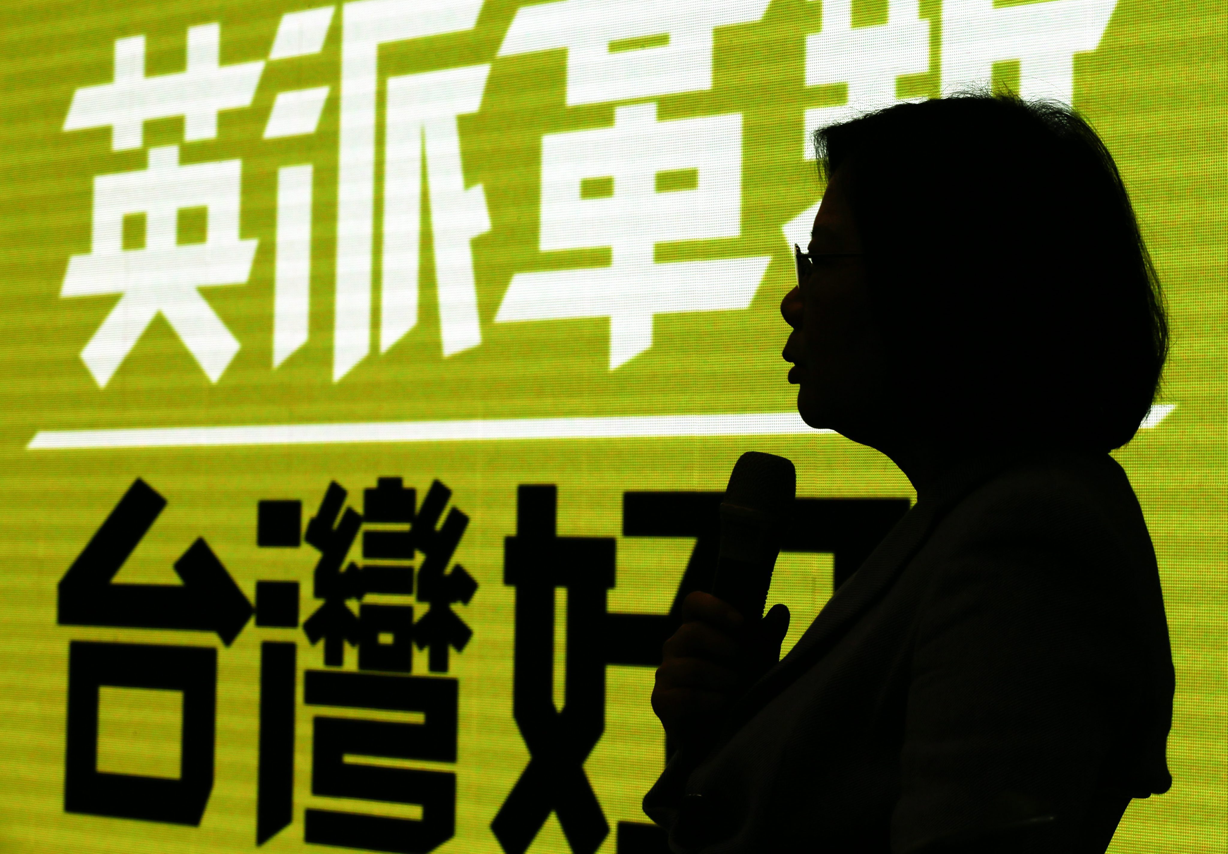 Taiwanese opposition leader and presidential candidate Tsai Ing-wen is silhouetted against a banner as she speaks during a news conference inside the Democratic Progressive Party headquarters in Taipei last month. Photo: EPA