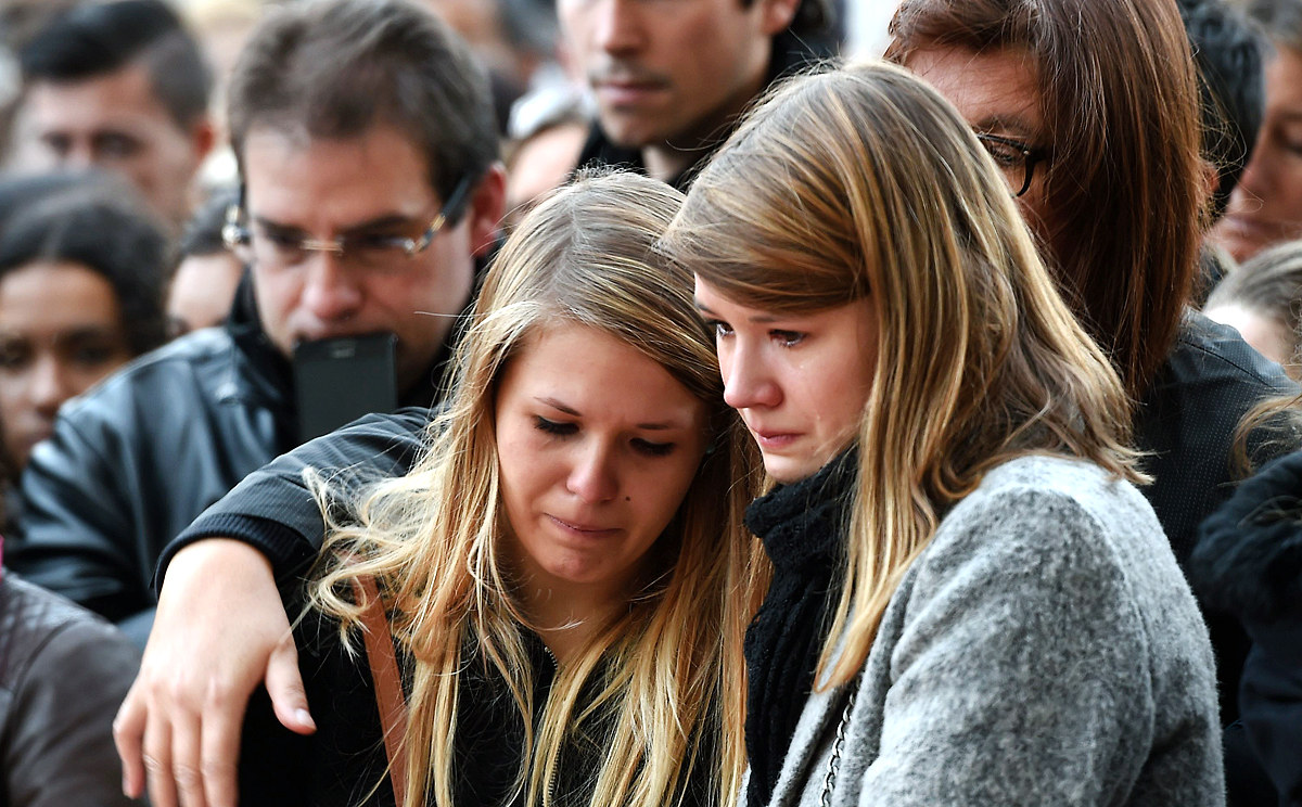 People mourn the dead at a makeshift memorial near the Bataclan concert hall in Paris, two days after a series of deadly attacks. Photo: AFP