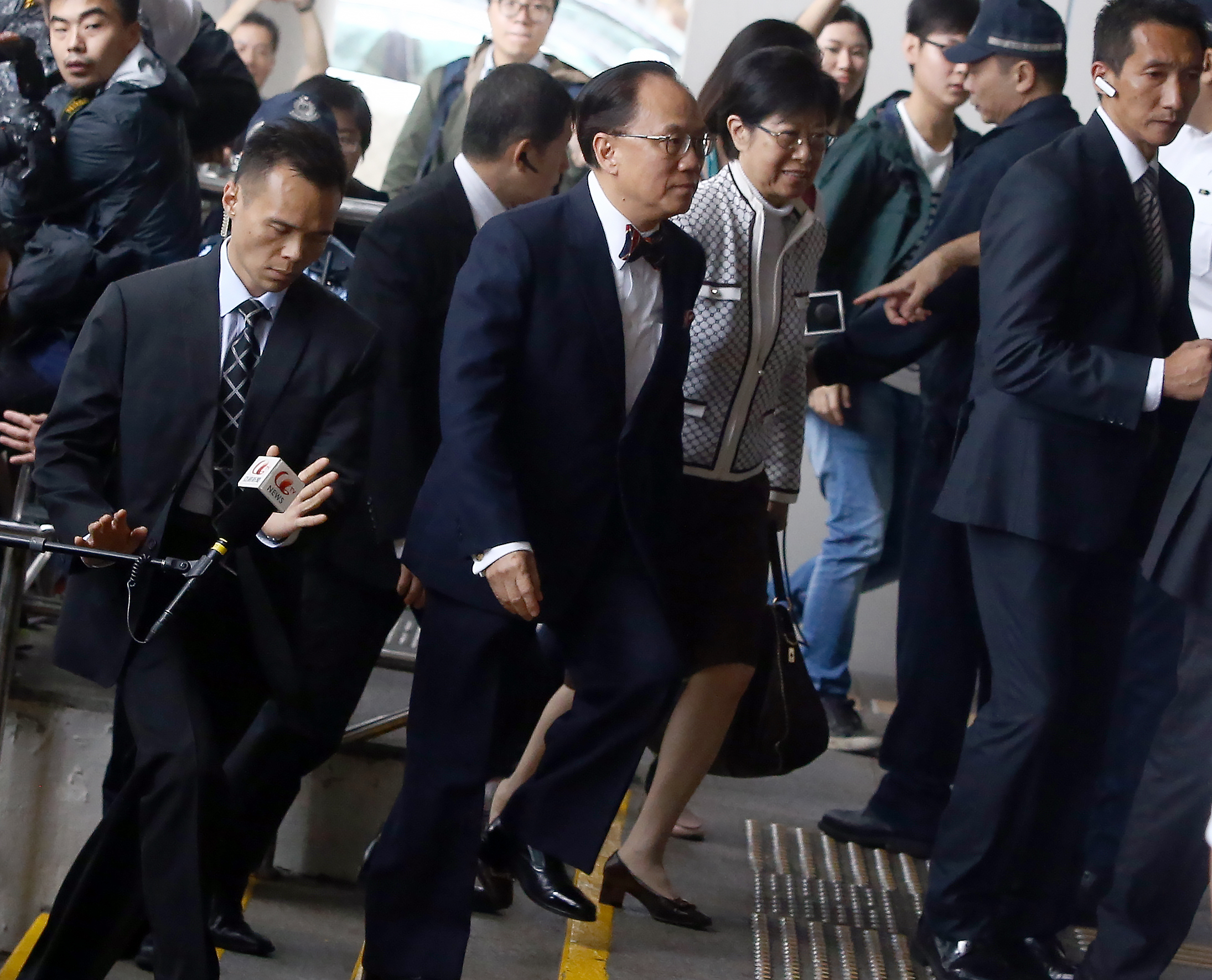 Donald Tsang Yam-kuen (centre) and his wife Selina Tsang Pou Siu-mei arrive at the Eastern Court for a hearing amid increased security. Photo: Sam Tsang