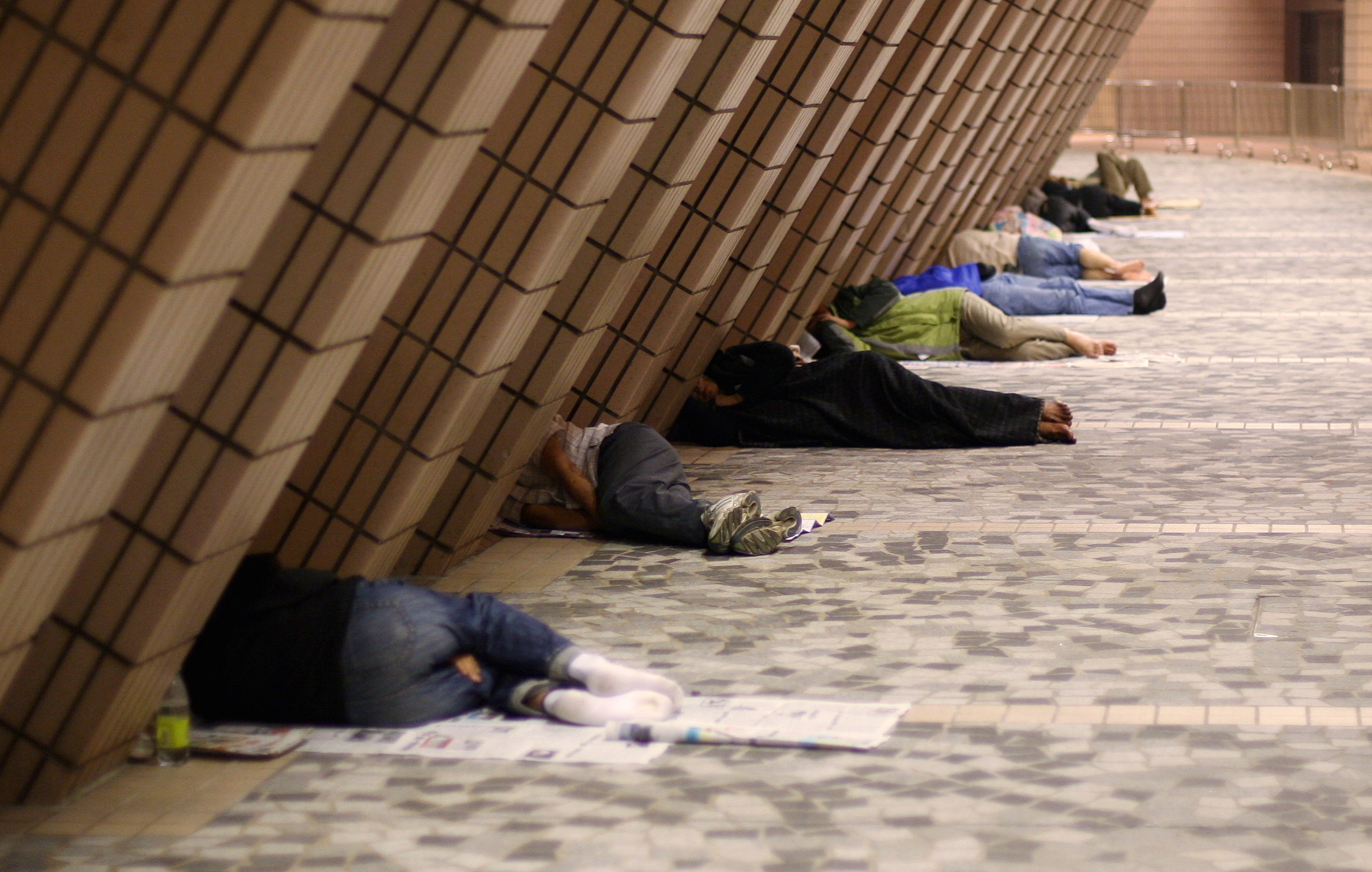 Street sleepers under the walls of the Hong Kong Cultural Centre in Tsim Sha Tsui.