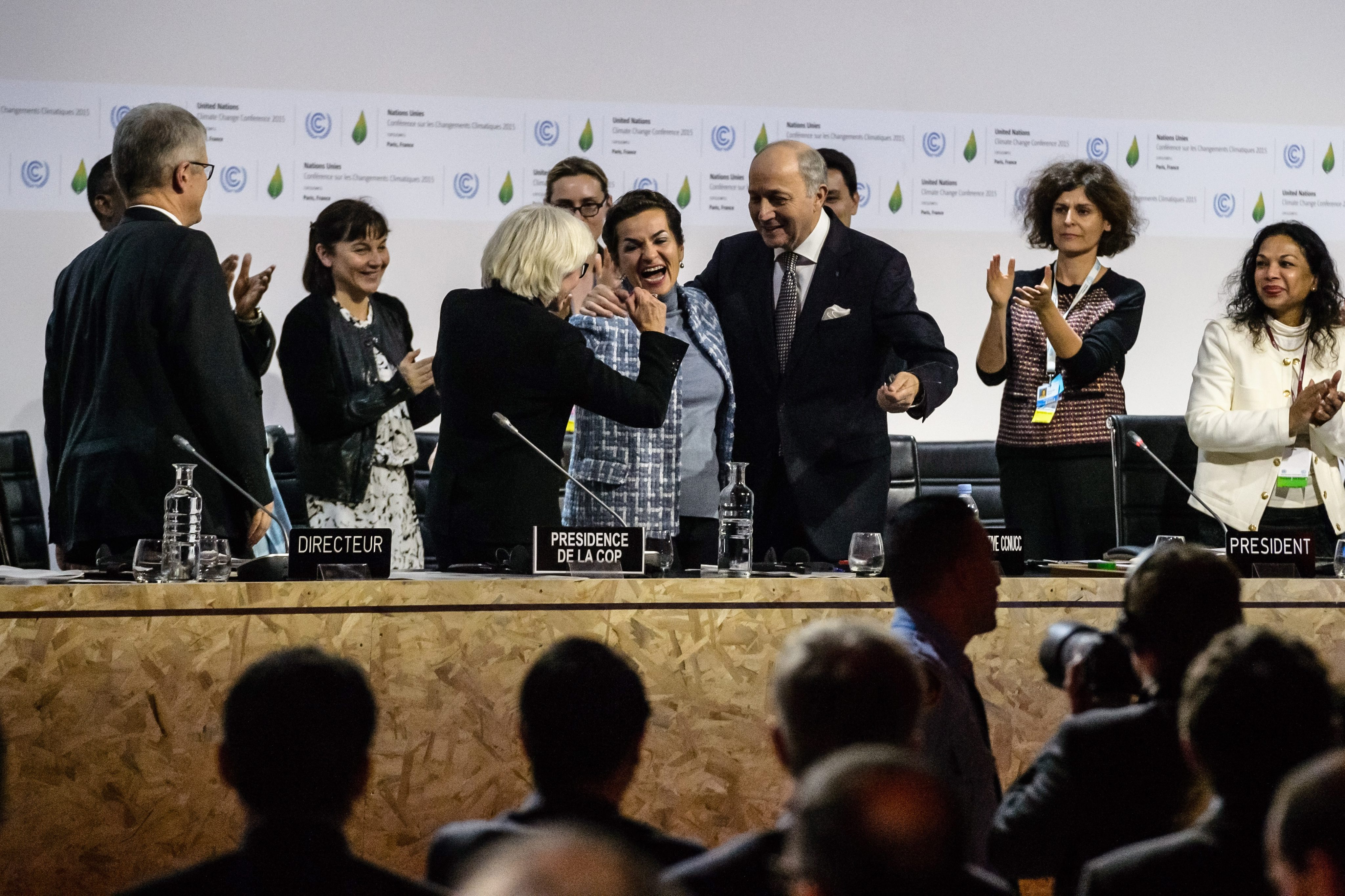 French Special Representative for the 2015 Paris Climate Conference Laurence Tubiana (third left), Executive Secretary of the UN Framework Convention on Climate Change Christiana Figueres (centre) and French Foreign Minister Laurent Fabius (third right) after the adoption of the COP21 final agreement at the World Climate Change Conference 2015 in Le Bourget, north of Paris. Photo: EPA