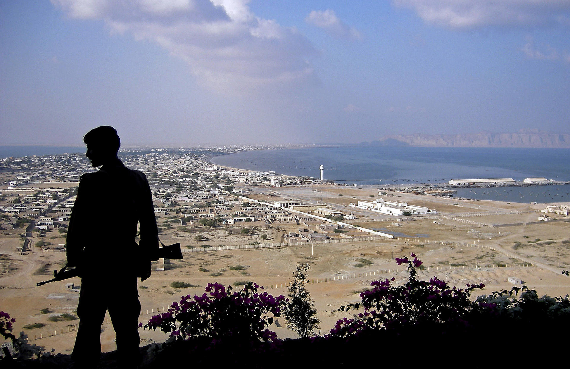 A Pakistani paramilitary soldier stands guard near where the Beijing-funded megaport of Gwadar, in southwestern Pakistan, will be built. Photos: AFP; Corbis; Imaginechina; Reuters
