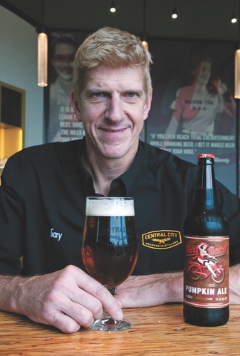 Gary Lohin, Central City Brewers and Distillers brewmaster, with a glass of Central’s Red Racer Spiced Pumpkin Ale Photo: Chung Chow