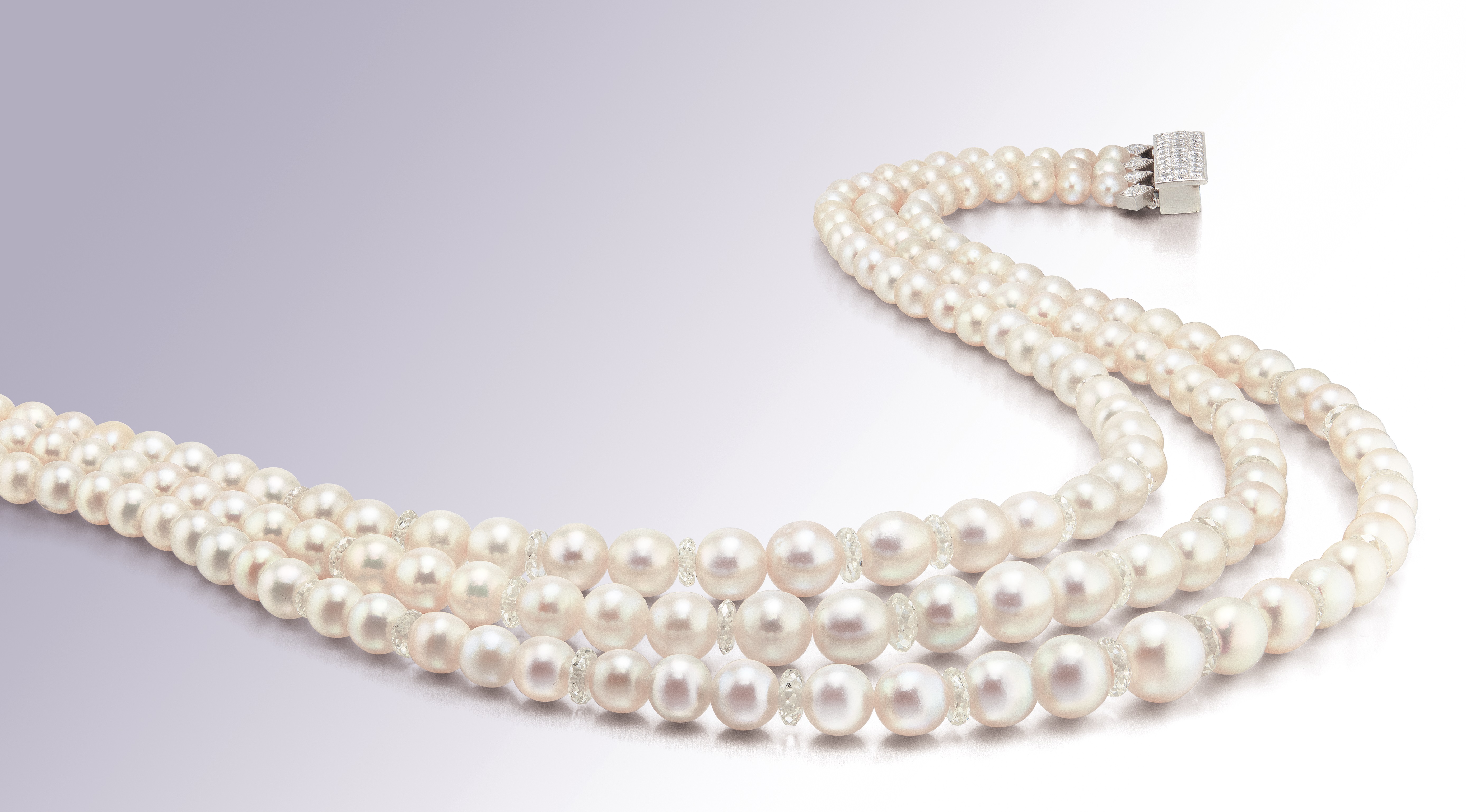 A Very Fine Natural Pearl and Diamond Triplestrand Necklace, Clasp signed Verdura Paris.