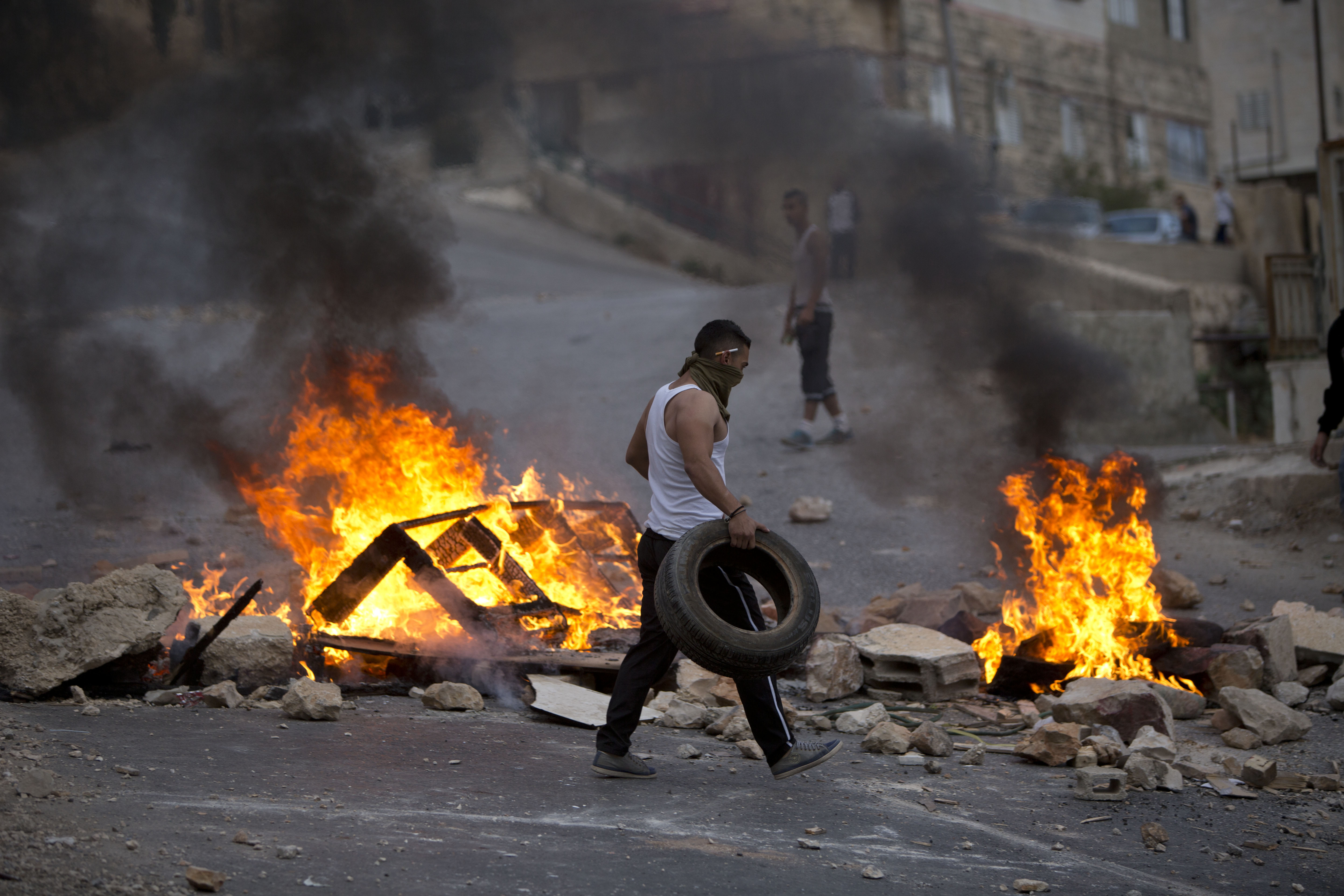 Palestinians burn tires during Israeli military raid in the West Bank city of Nablus on Tuesday. Photo: AP