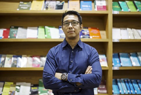 Min Zaw Oo poses for a photograph in the Myanmar Peace Center in Yangon October 7, 2015. Min Zaw Oo is a senior official at the government-linked Myanmar Peace Center, which coordinates talks to quell the patchwork of insurgencies that have lingered in Myanmar since independence in 1948. Min Zaw Oo, top negotiator in Myanmar's peace talks with ethnic rebels, has accused neighbouring China of derailing a nationwide ceasefire deal last week that would have brought Japan and Western nations in as observers to monitor an end to decades of conflict. Beijing has denied the accusation but the rare public criticism exposes growing tensions between China and the Southeast Asian nation, which has sought to reduce its dependence on Beijing and build relations across the globe since a reformist government took power in 2011. To match story MYANMAR-CHINA/ Picture taken October 7, 2015. REUTERS/Htoo Tay Zar