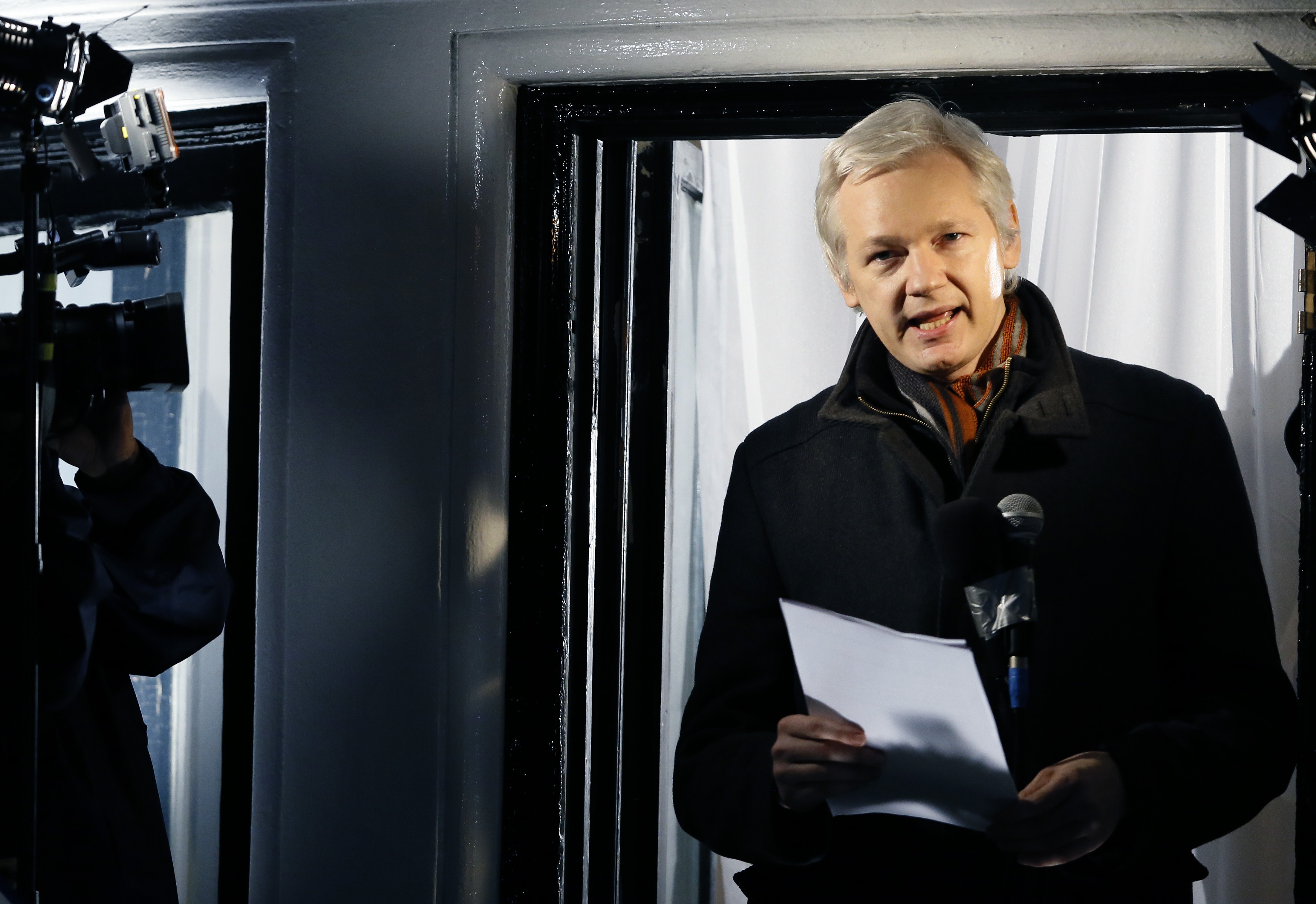 FILE - In this Thursday, Dec. 20, 2012, file photo, Julian Assange, founder of WikiLeaks speaks to the media and members of the public from a balcony at the Ecuadorian Embassy in London. British police have removed the officers standing watch over Julian Assange outside the Ecuadorean Embassy in London, but say they will still do their best to arrest the WikiLeaks founder who has been holed up there since June 2012. London's Metropolitan Police said in a statement Monday, Oct. 12, 2015, that Assange is still subject to arrest for failing to answer a rape charge in Sweden. (AP Photo/Kirsty Wigglesworth, File)