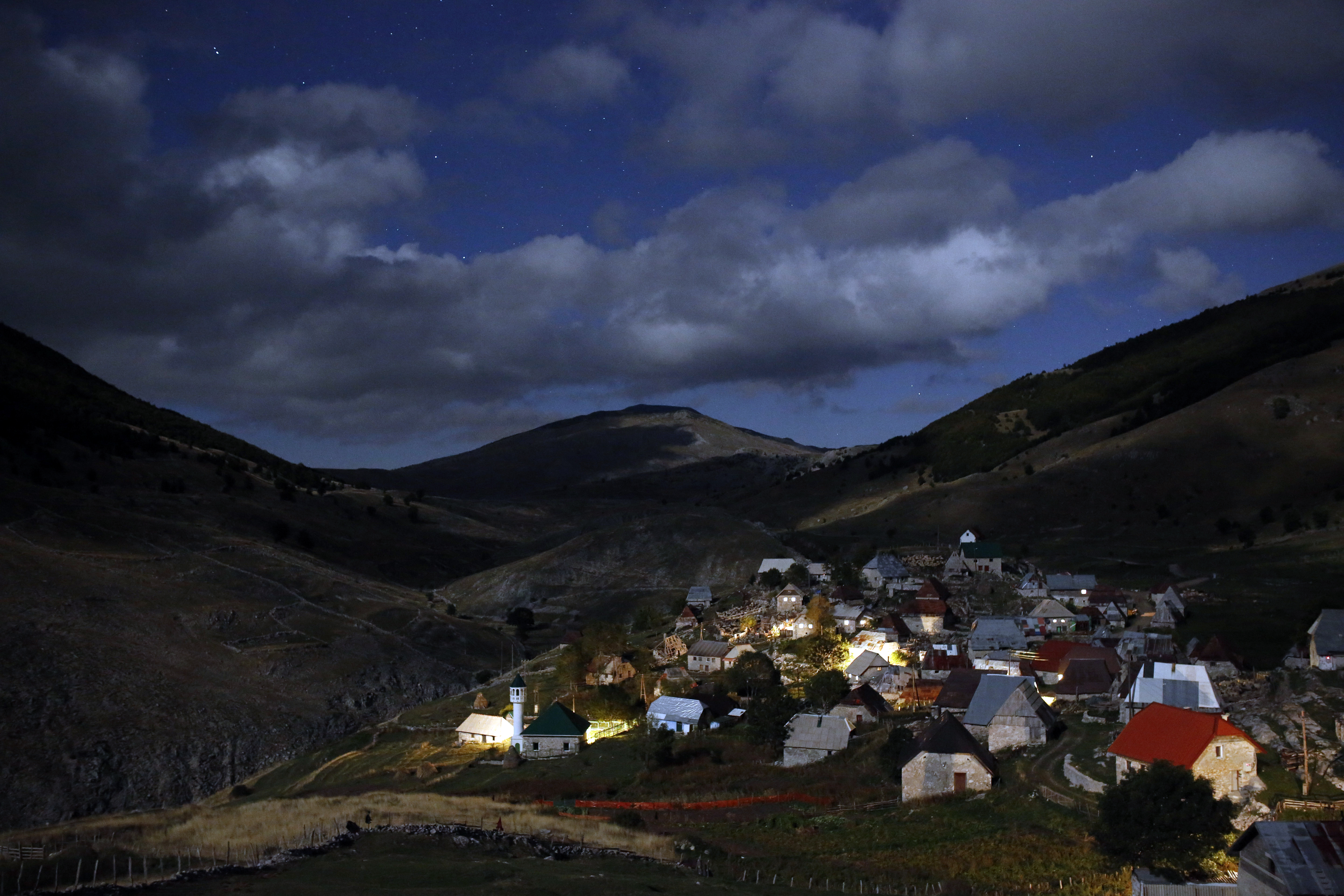 A mountain village is illuminated by moonlight as the 50 residents of village prepare to celebrate the Muslim holiday of Eid al-Adha, in the remote mountain village of Lukomir, 50 kms south of Sarajevo, on Thursday, Sept. 24, 2015. Bosnian Muslims will slaughter cattle later, with the beef and meat distributed to the needy for the holiday which honors the prophet Abraham for preparing to sacrifice his son on the order of God, who was testing his faith. (AP Photo/Amel Emric)