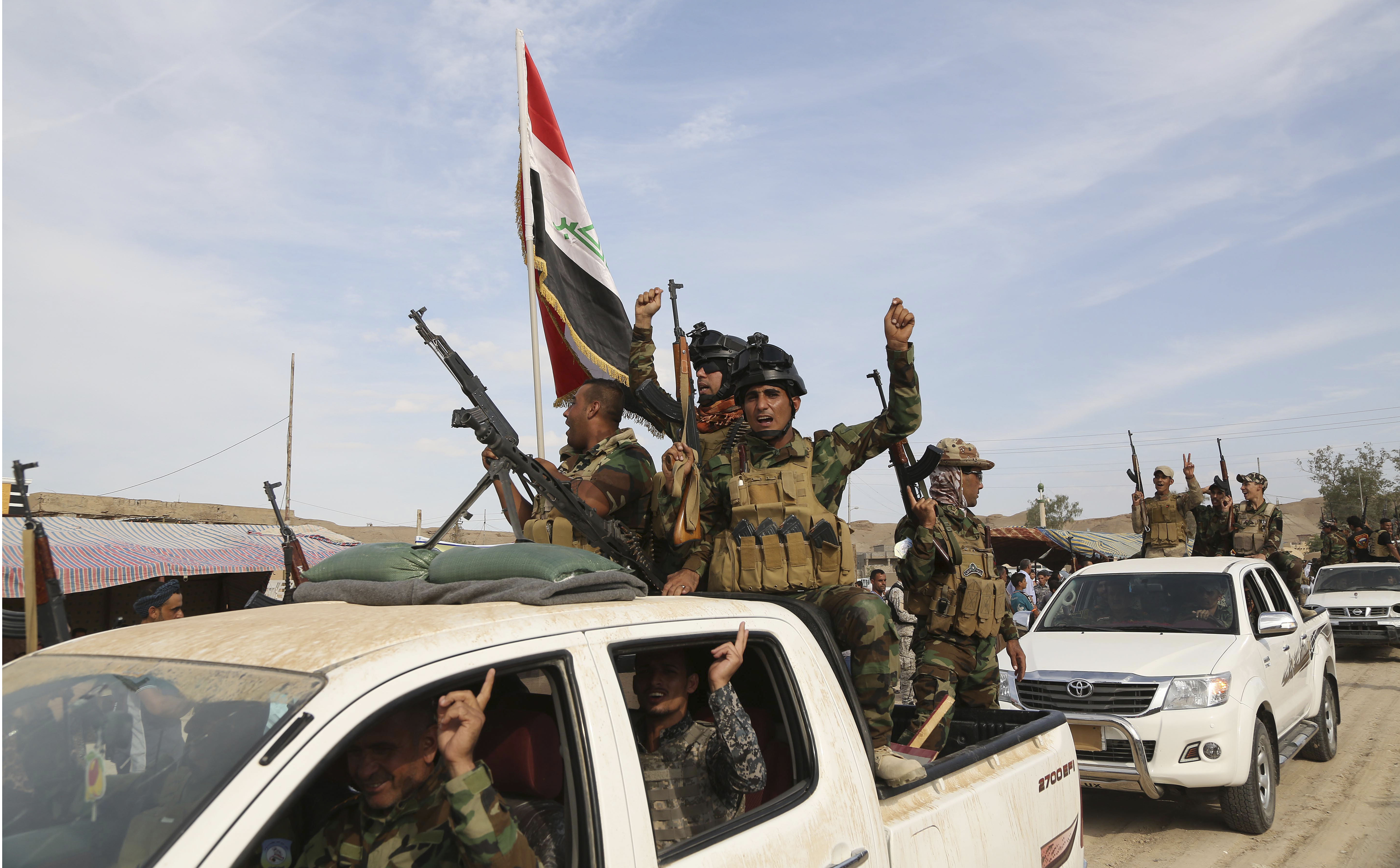 Sunni volunteer fighters parade as they prepare to support Iraqi security forces in liberating the city of Ramadi from Islamic State group militants, in Khalidiya, 60 miles (100 kilometers) west of Baghdad, Iraq, Saturday, Oct. 10, 2015. (AP Photo/Karim Kadim)