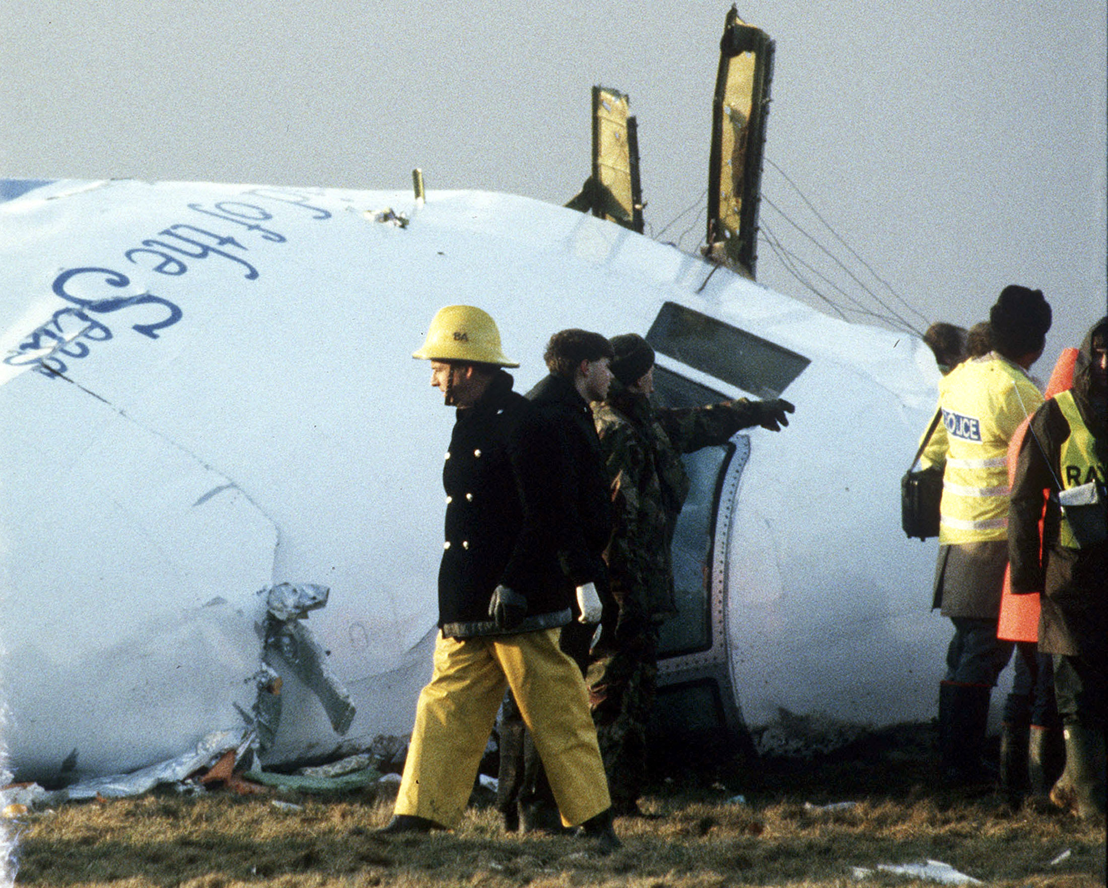 A December 23, 1988 file photo shows Scottish rescue workers and crash investigators search the area around the cockpit of Pan Am flight 103 in a farmer's field east of Lockerbie, Scotland. Scottish and U.S. investigators have identified two Libyan suspects believed to have been involved in the 1988 Lockerbie airline bombing which killed 270 people, Scottish prosecutors said on Thursday. REUTERS/Greg Bos