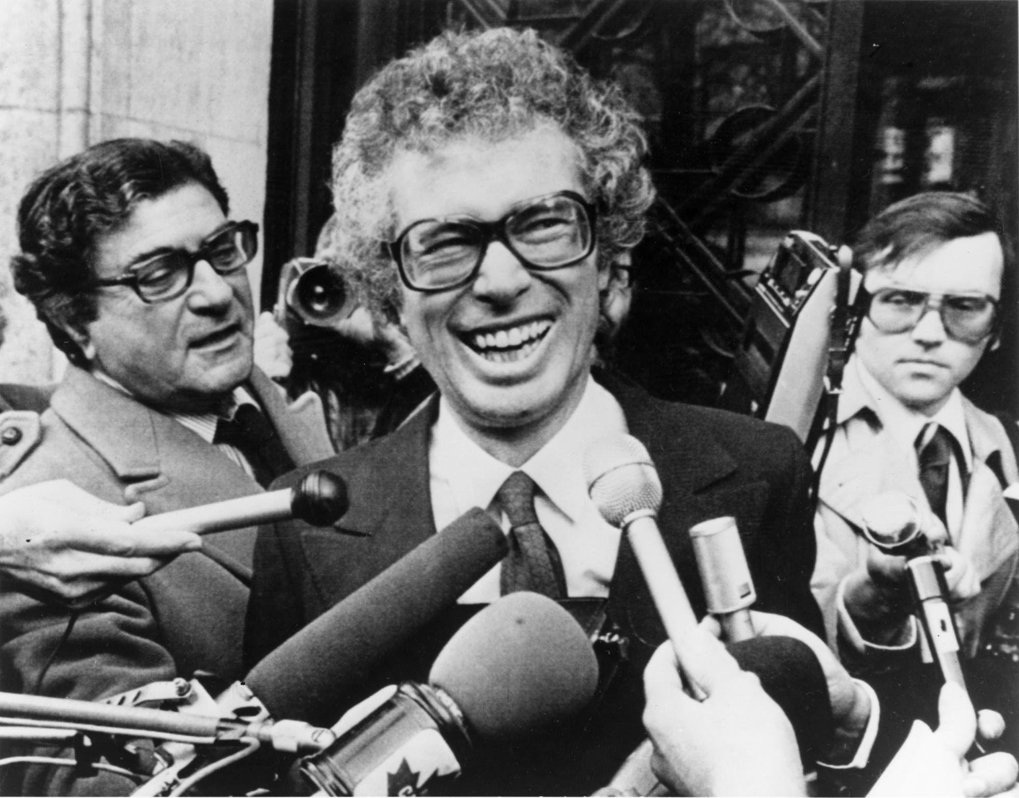 FILE - In this Jan. 31, 1980, file photo, Ken Taylor, Canadian Ambassador to Iran, laughs as he answers questions during a meeting with journalists outside the Canadian Embassy in Paris. Taylor, who kept Americans hidden at his residence during the 1979 Iran hostage crisis, died Thursday, Oct. 15, 2015, after a two month battle with colon cancer, his wife Pat said. He was 81. (AP Photo/File)